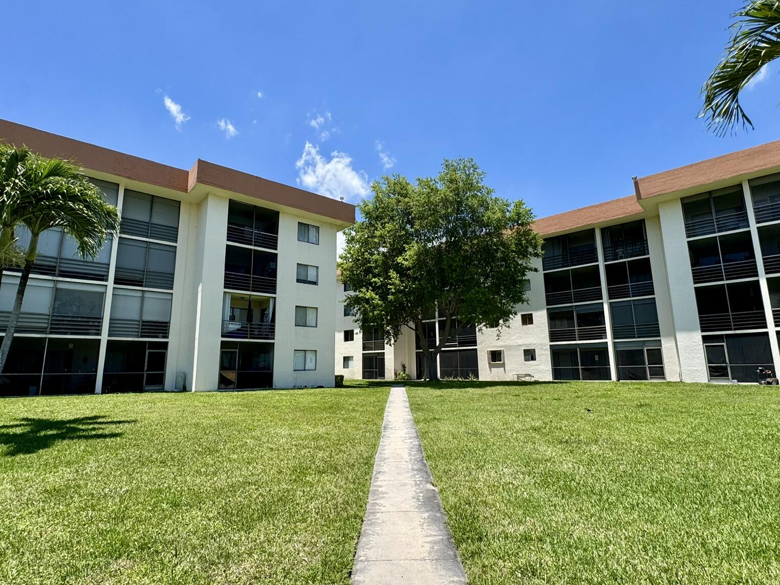 MOVE IN OR RENT IMMEDIATELY - Spacious 3-bedroom, 2-bath condo in Olympus Village, ideally located in the heart of Lantana. Situated on the second floor, this light and bright residence offers over 1,240 square feet under air with a functional split-bedroom layout, in-unit washer and dryer, newer appliances and updated kitchen, as well as generous storage throughout. Two of the bedrooms feature walk-in closets, and the large screened balcony includes an additional storage closet with peaceful views of the pool, trees, and surrounding green space.  Market rents for similar units are averaging around $2,800/month. The community is professionally managed and offers amenities including a pool, elevator access, and ample parking.  The association has completed its Structural Integrity Reserve Study and milestone inspection, providing a clear plan for long-term maintenance and reserves. HOA includes common area maintenance, water, sewer, trash, cable, and amenities.  Olympus Village Condominium is centrally located near Palm Beach State College, John Prince Park and Recreation, Palm Beach County Park Airport as well as hospitals, schools, I-95, shopping, grocery stores, restaurants, major highways and near the beach.