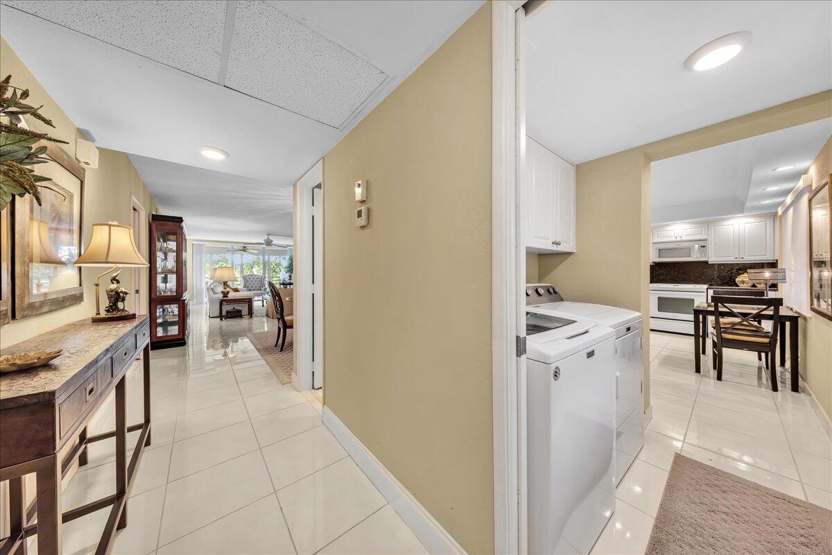 ** Elegant and spacious 3BR/2.5BA "F" model, beautifully updated.  Features tile and laminate flooring, a bright eat in kitchen with full size side by side washer and dryer, and inviting dining space.  Upgrades include A/C (2020), kitchen remodel (2011), and water heater (2004).  Building offers a new roof (2022) and completed 40 year safety certification.  Nestled in a lush, PET friendly community with two resort style pools, grilling areas, and same floor storage.  Two pets up to 15" welcome.  Association requires 700+ credit score, 20% down, and two years ownership before leasing.  Pickleball and tennis nearby at the Park.  Shopping, entertainment at THE POMP, restaurants, fitness centers, and beaches all nearby.  Come make Palm Aire your new home!