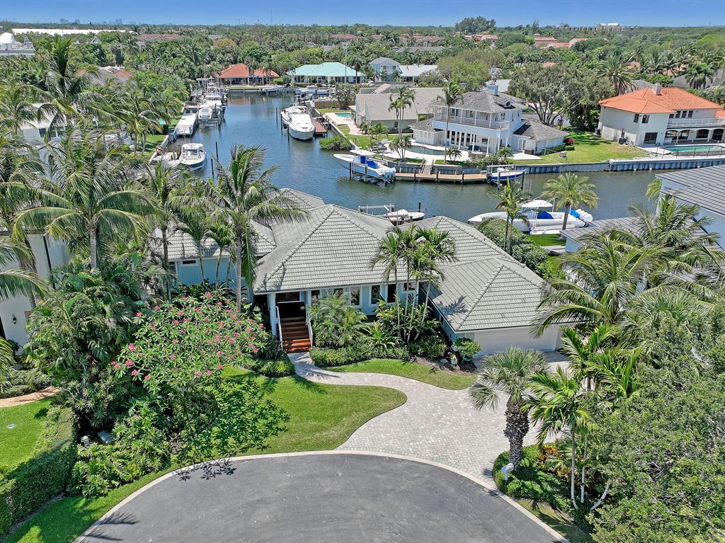 Unique custom -built home. 90 Foot dock with 12,000 K lift. Open floor plan includes 3 bedrooms with sliders to decks, office, 2 1/2 baths, dining room, living room with fireplace and exquisite built-in wood cabinets. Hardwood floors. 2 car garage with storage above. Impact glass. Pool with multi- level South African Hardwood decks, large, covered patio with fan, Cathedral ceilings with tongue and groove wood and exposed beams throughout. Primary bedroom two sets of sliders to exclusive private deck, view of Intracoastal waterway from East window. Wide water views. Boat lift set to the side to not obstruct view. Gated Bay Village, house on large Cul de sac setting home back from other homes providing privacy in back of home. Professionally designed lush landscaping, Orchids throughout Great location for boating. 5 houses from Intracoastal waterway between Palm Beach inlet and Jupiter inlet. Multiple waterfront restaurants just outside neighborhood easy boat access. 3 miles to beaches, golf at North Palm Beach CC. 1 ml to Gardens mall and great restaurants on PGA Blvd. 9 miles to Jupiter waterfront restaurants, 15 miles to West Palm Beach, Palm Beach, and airport.
  South African hardwood 90 ft dock with water and electric. Cement seawall cap. Kayak dock with ladder. Piling bumpers and ladder on main dock. 12 K lift mounted off center on Westside to not obstruct wide water view. Dock box. Wide water makes for easy maneuverability.
Property being sold AS-IS WITH RIGHT TO INSPECT. All measurement are approximate. Buyer should verify measurements and fees.
With offer proof of funds and or pre-qualification letter.

House is raised (Key West Style). From garage 4 steps up to guest bedrooms and bath. 4 steps up to main living area. 3 steps to primary bedrm and bath.