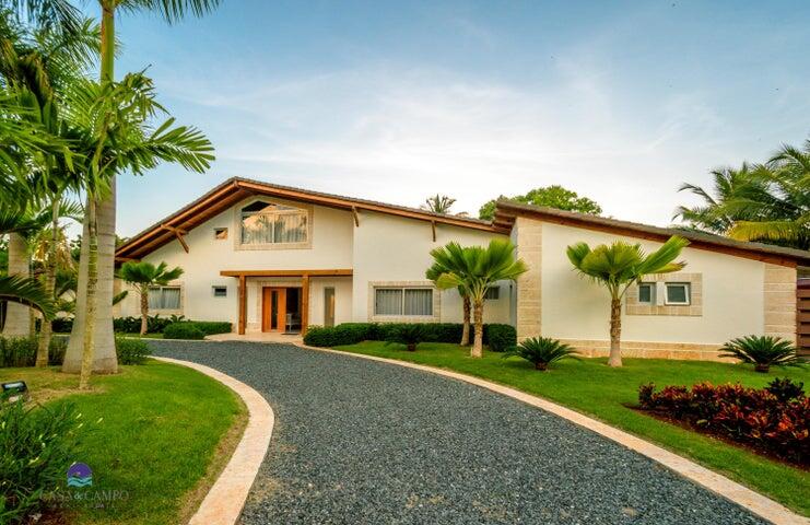 Spacious custom built modern style villa with lake and golf views on a vastly oversized lush landscaped property. Large pool and Jacuzzi, each heated independently. Circular driveway with illuminated gate posts. Recently renovated.