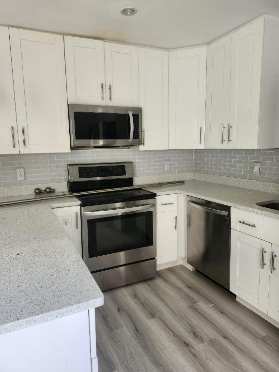 You're gonna love this Central Boca 2 Bedroom , 2.5 bath townhome  in an A+ Gifted School District. Walk to Shopping ...Situated Between  I 95 and the Turnpike, Walk to multiple houses of worship...Community Pool ...
Enter Your Private Courtyard that leads to your New Front Door ,Freshly painted,luxury vinyl flooring on the first floor, redone contemporary white kitchen with quartzite counters and stainless steel appliances under stair storage ,powder room ,Eat In Kitchen, Living & Dining Rooms downstairs ,Upstairs you'll Find two en suite(redone)bedrooms, laminate flooring(no carpeting) and Partial Hurricane Protection....Must See Won't Last!