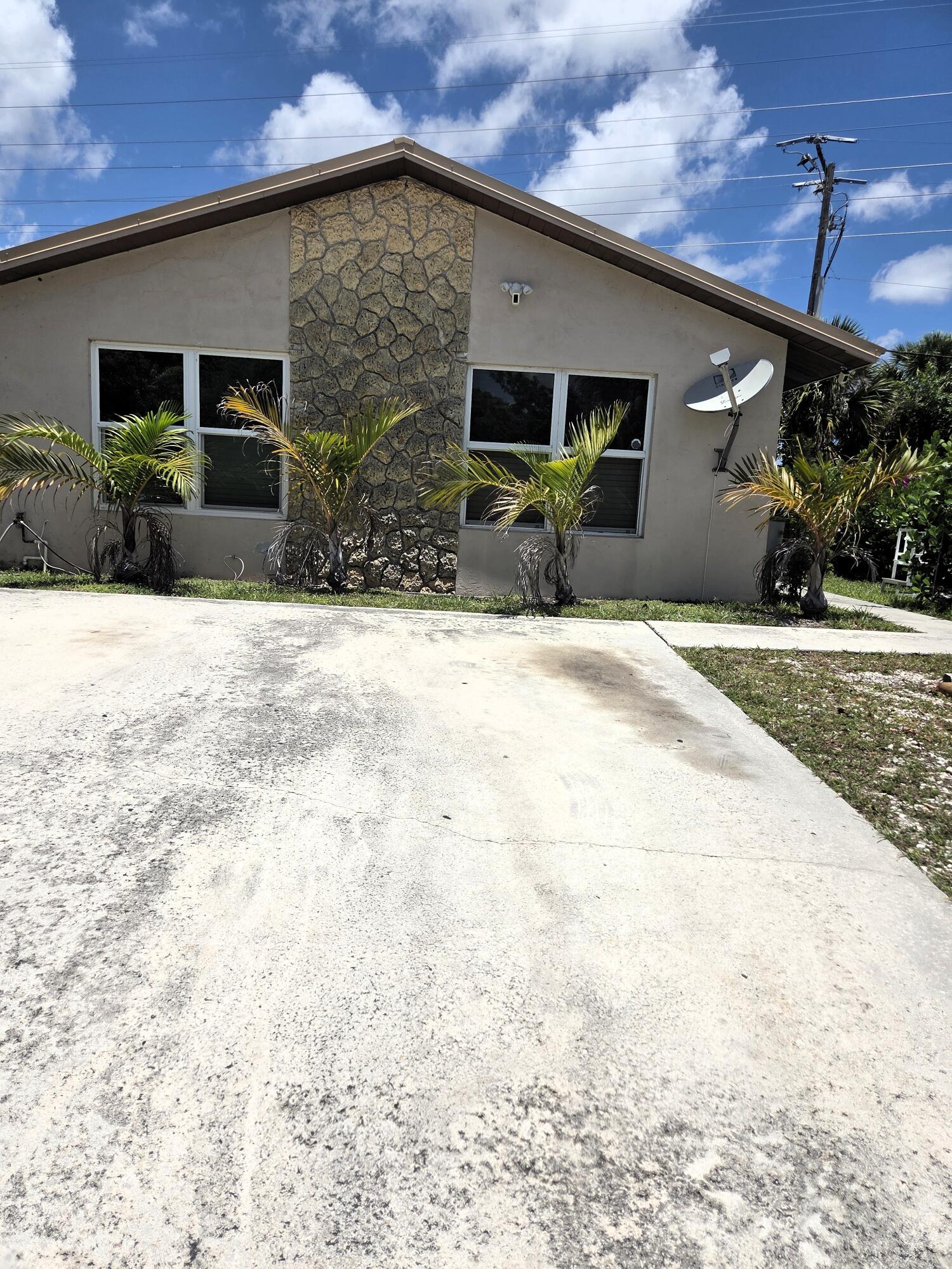 MOSTLY IMPACT WINDOWS AND DOOR, NEWER ROOF AND SOLAR PANELS.  Great opportunity to own your own home near shopping, major roads, palm beach airport and more.  Recently painted,  All Vinyl floors (squares in main areas, newer plank flooring in laundry rm, bathroom and patio area.