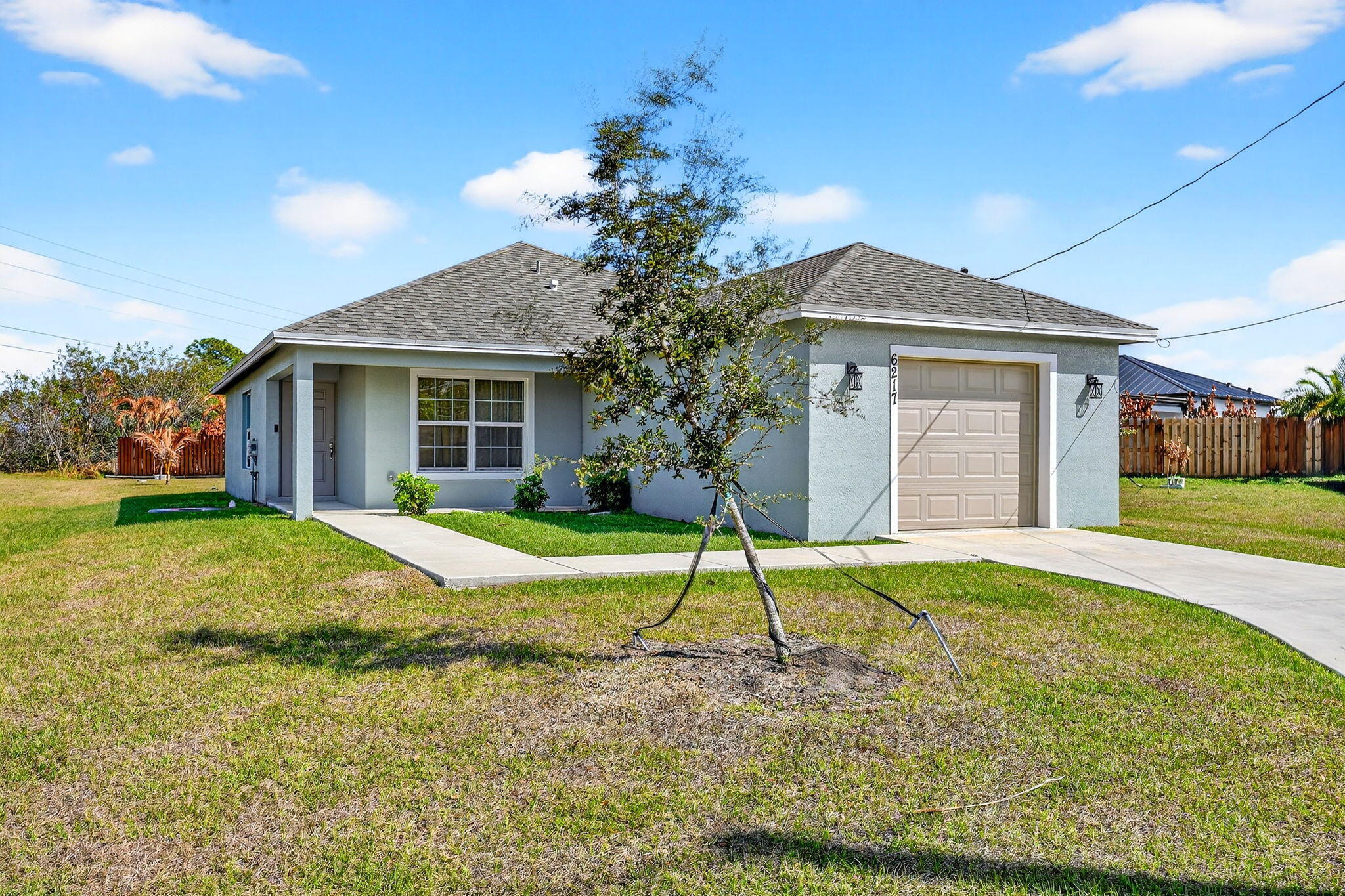 This is a 3 bedroom, 2 baths home with a one car garage.  It is conveniently located in a cul-de-sac in a prime area of Port Saint Lucie.  The home was built in 2024 and has been well maintained.  It features a modern open floor plan with carpet and laminate flooring in main living areas.  It includes a primary suite with a walk in closet, a utility room for laundry. The exterior has a neutral color and plenty of land to accommodate a pool and a large garden.