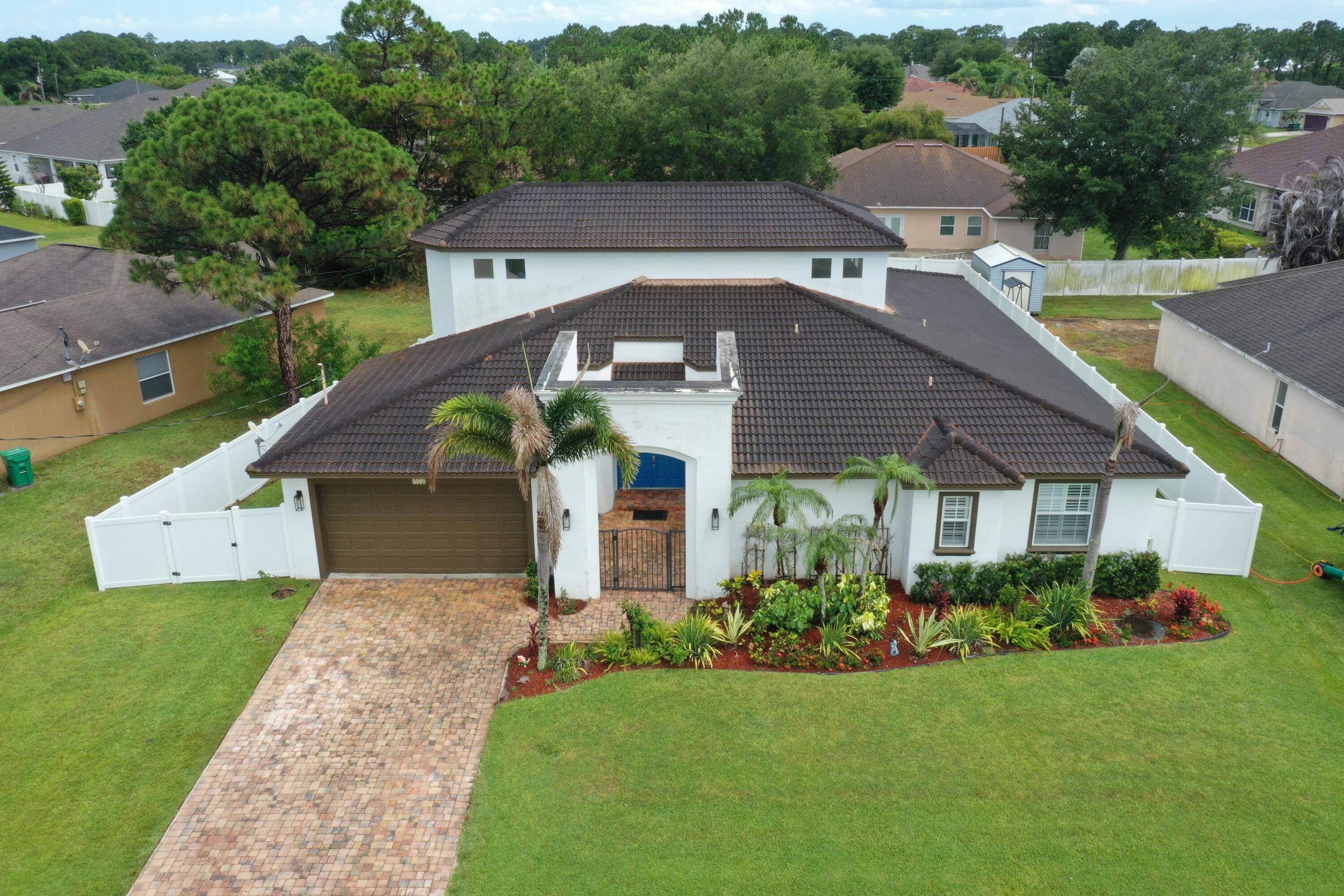 Luxurious CBS built 2007 Mediterranean style home with countless upgrades and full of natural light. Soaring 20' ceilings in the kitchen and family room with crown moulding. The stunning kitchen boasts an abundance of granite counter space, custom cabinetry and a substantial island with storage. Four graciously sized bedrooms and 3.5 baths gives everyone their own space while the large living room welcomes entertaining. The primary suite features a walk-in closet, dual sinks, and a soaking tub. The lush backyard is enhanced by a new fence and an extended screened lanai offering privacy and comfort.