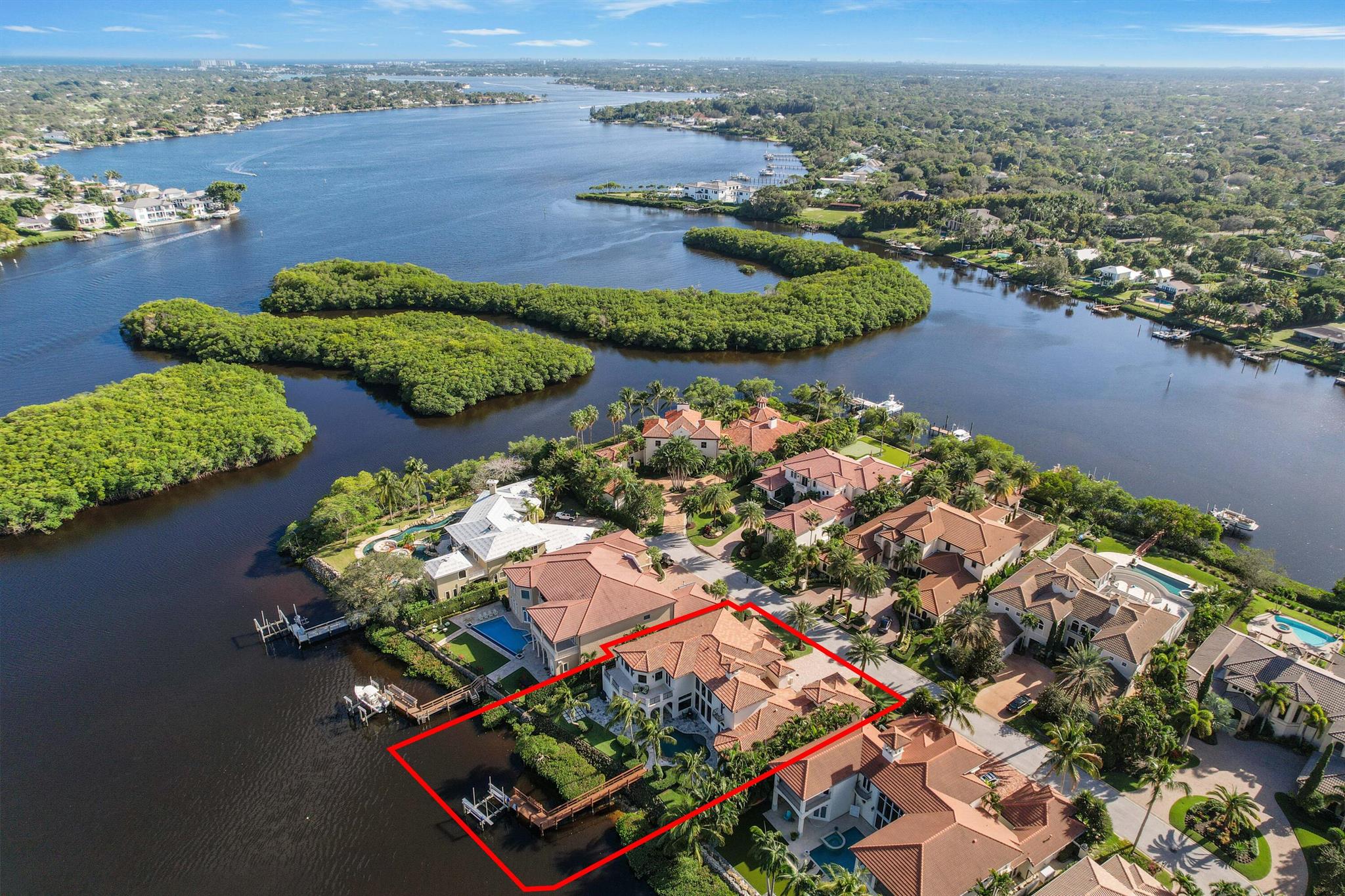 Grand Estate in the private gated community of Reach Island in the Islands of Jupiter. This custom-built waterfront home boasts 105 feet of panoramic water views, offering access to the ocean with NO fixed bridge. A new 16,000 lift surrounded by lush tropical landscaping, while the saltwater heated resort-style pool and spa adds to this serene oasis. Step inside this stunning 5-bedroom, 6 bath residence, where luxury meets comfort.  The first-floor primary suite spans over 1200 SF, offering a haven of tranquility. Revel in the dual luxury of two separate bathrooms, a cozy sitting area, a convenient coffee bar, and custom closets with marble and hardwood flooring. The heart of this home lies in its gourmet kitchen, boasting beautiful countertops and top-tier appliances including a Wolf range with a gas double oven, microwave and two Sub-Zero refrigerators. This culinary kitchen extends into a spacious family room with beautiful Crema Marfil stone flooring, a large pantry and a convenient desk area.

Entertain in the formal dining and living room with a beautiful decorative fireplace, or escape into the 2-story study/library with custom wood finishes and fireplace. A cinematic experience in the seven-seat theater room equipped with surround sound.

This home ensures both comfort and resilience, featuring a 60 kw propane home generator, complete impact glass, central vacuum system, and an elevator for seamless access across multiple levels.

Indulge in the finest of living just moments away from upscale dining and premier shopping destinations!"