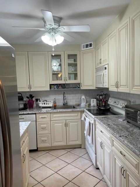 Nice updated kitchen light and airy 2 bedroom and a 2 full bathrooms home tiled throughout with garden view washer and dryer in a resort style community  2 club house with a cafeteria indoor and outdoor pools, a gym theater with live showers and movies  courtesy buses a bistro indoor monaco club house tennis, golf Course and more close to the beach and restaurants  Occupied make an appt first  Move in 3 months