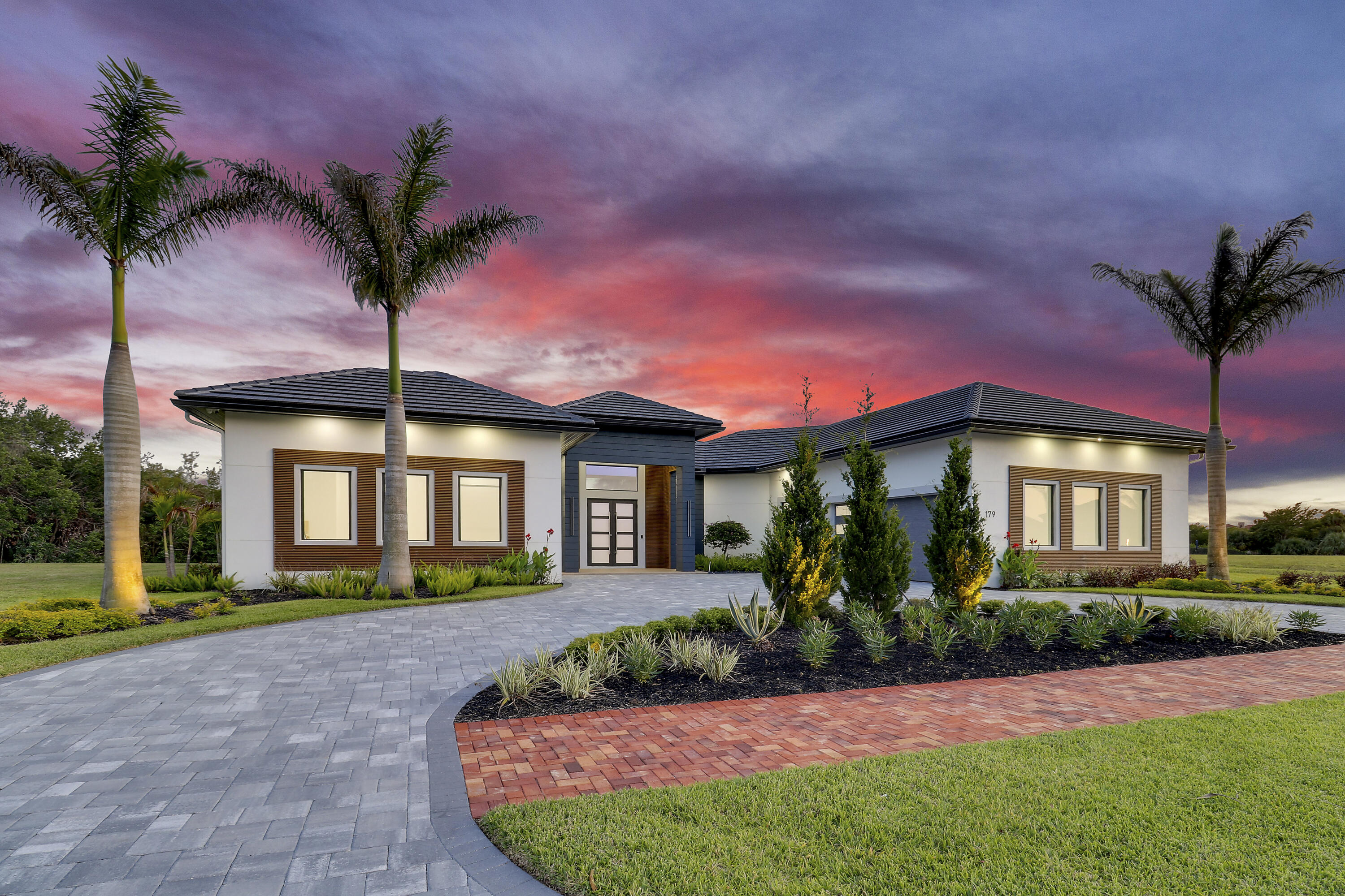 Experience refined living in this exceptional 4-bedroom, 4-bathroom luxury residence, ideally positioned just steps from the scenic St. Lucie River. Designed with a focus on elevated living and modern sophistication, this home showcases an impressive array of high-end upgrades from the moment you arrive. Inside, porcelain tile flooring flows seamlessly throughout, complemented by a designer LED lighting package that highlights the home's clean lines and architectural detail. The chef-inspired kitchen is a true showpiece, featuring striking porcelain countertops, a highly sought-after double island layout, a built-in ice maker, and an upgraded pantry, perfectly designed for both everyday functionality and upscale entertaining. Smart home innovation meets energy efficiency with a fully integrated Savant system controlling security cameras, audio, and access points, while foam insulation throughout (including block-injected walls and the garage), insulated garage doors, and a gas tankless water heater provide superior comfort and cost efficiency. The garage is equally refined with sleek epoxy flooring, creating a polished and functional space. The primary suite is enhanced by a fully finished luxury closet, offering both elegance and organization, while every detail throughout the home reflects thoughtful craftsmanship and premium quality.  Step outside to a private outdoor retreat designed for year-round enjoyment. The covered patio opens to a resort-style pool area featuring an automated Shandy pool system, paired with a fully equipped summer kitchen, ideal for entertaining guests or relaxing in your own tropical escape. Whether hosting gatherings or enjoying quiet evenings, the indoor-outdoor flow of this home is simply unmatched.  Located just moments from the water, this residence also offers access to a grand social hall, enhancing the overall lifestyle experience. Combining luxury finishes, smart technology, and an unbeatable location near the St. Lucie River, this home represents a rare opportunity to enjoy the very best of Florida living.