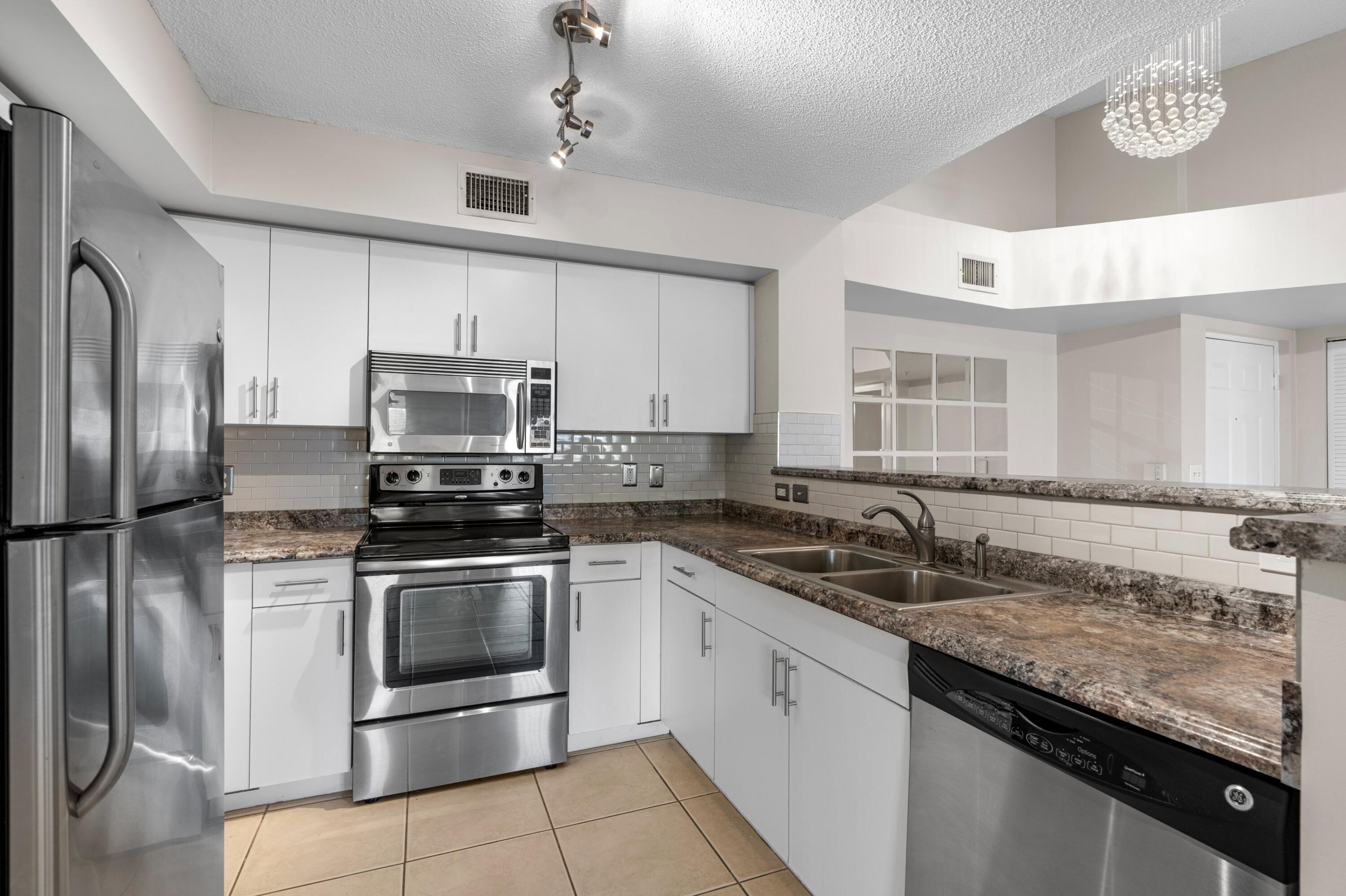 Welcome home to this beautifully maintained 2 bedroom, 2 bathroom lakefront condo located in the desirable gated community of Carrington at Coconut Creek. This inviting residence features an updated kitchen with sleek countertops, stainless-steel appliances, creating the perfect space for both everyday living and entertaining and a washer & dryer in the unit. The spacious and split floor plan offers comfortable living areas filled with natural light, while the generously sized bedrooms provide privacy and relaxation. The primary suite includes an en-suite bathroom and ample closet space for added convenience. Enjoy peaceful lakefront surroundings and resort-style community amenities within a secure gated setting. Ideally located near shopping, dining & so much more!