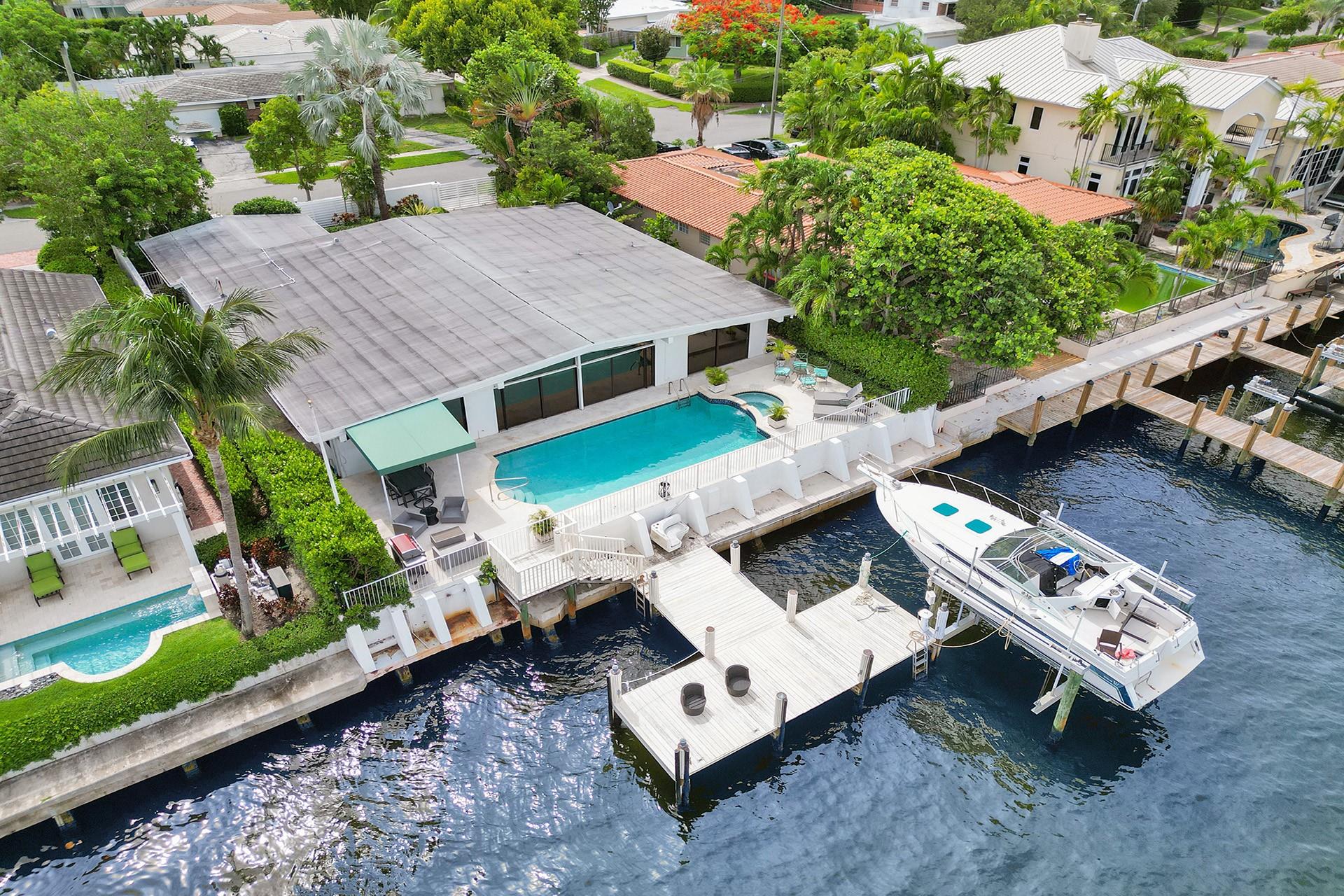 DIRECT OCEAN ACCESS!  4BD/3.5BR GATED POOL home in coveted Harbour Heights. Walk in & be greeted by breathtaking water views thru sliding doors that open to a pool, great deck & well-maintained dock—perfect for boating enthusiasts, mins to the ocean. This exceptional property features a tri-split layout ensuring privacy for guests, in-laws, or nanny &  primary suite w/ ABUNDANT closet space & SPACIOUS bathroom. Enjoy a BIG kitchen w/ eat-in dining area & an OVERSIZED living room. This home offers a blend of its EXCELLENT LOCATION AND OPPORTUNITY. Close to beaches, shopping, restaurants, airports, & highways. Priced VERY well for the area & previously used for successful short-term rentals, this property is a fantastic investment all around! Don’t miss the chance to make it your own!