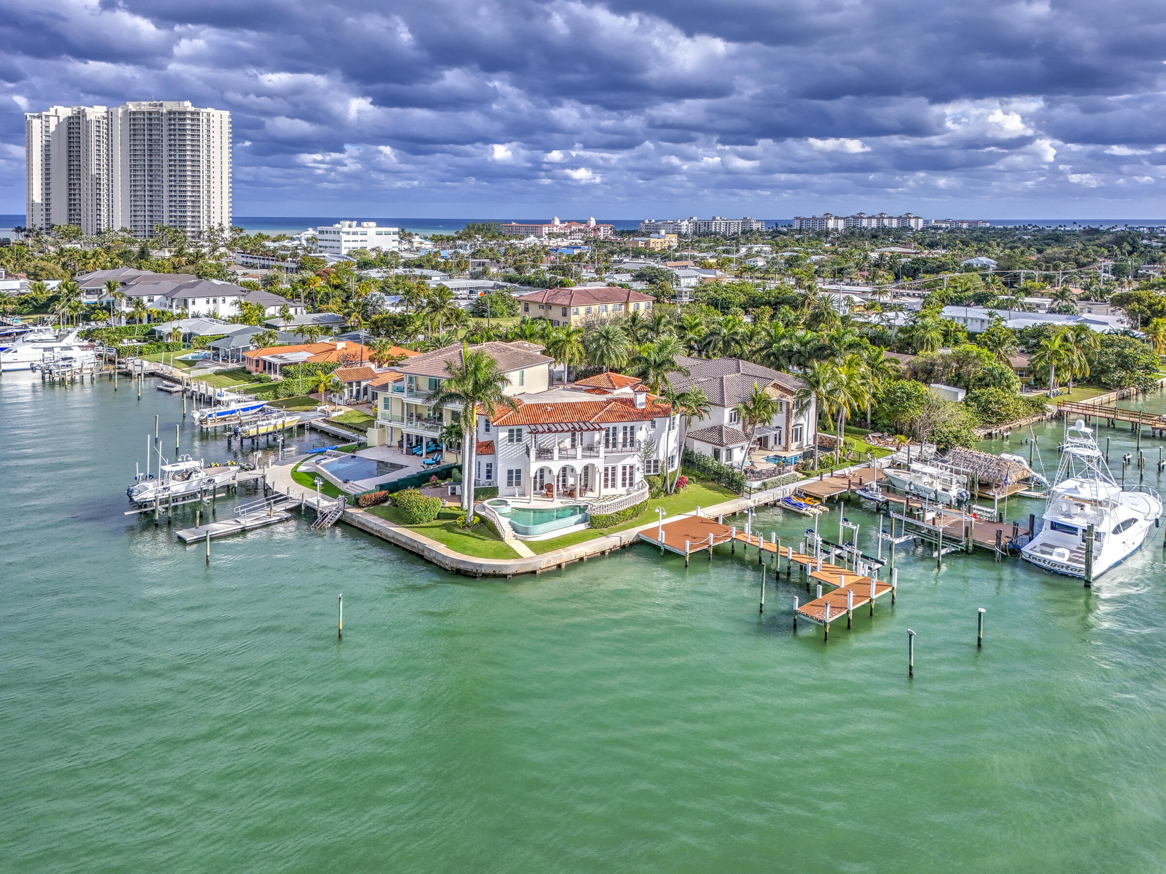 Experience the pinnacle of coastal living in the exclusive Sophia Seneca Estates, the only gated single-family subdivision on Singer Island. This magnificent 4-bedroom, 5-bathroom estate is perfectly tucked into a private, minimal-wake cove, offering 150 feet of direct Intracoastal and canal frontage.  Deep-Water Dockage: A true yachtsman's dream, capable of accommodating a 100'+ vessel with ample additional space for multiple boats and jet skis.  Equipped for Performance: Features a 40,000 lb boat lift for secure and convenient access to the water.  Enjoy the rare, crystal-clear water unique to this specific cove on the Island.  Designed to maximize its stunning surroundings, the home offers 2-mile wide-water views and vistas from nearly every room.  A sprawling patio designed for sunsets