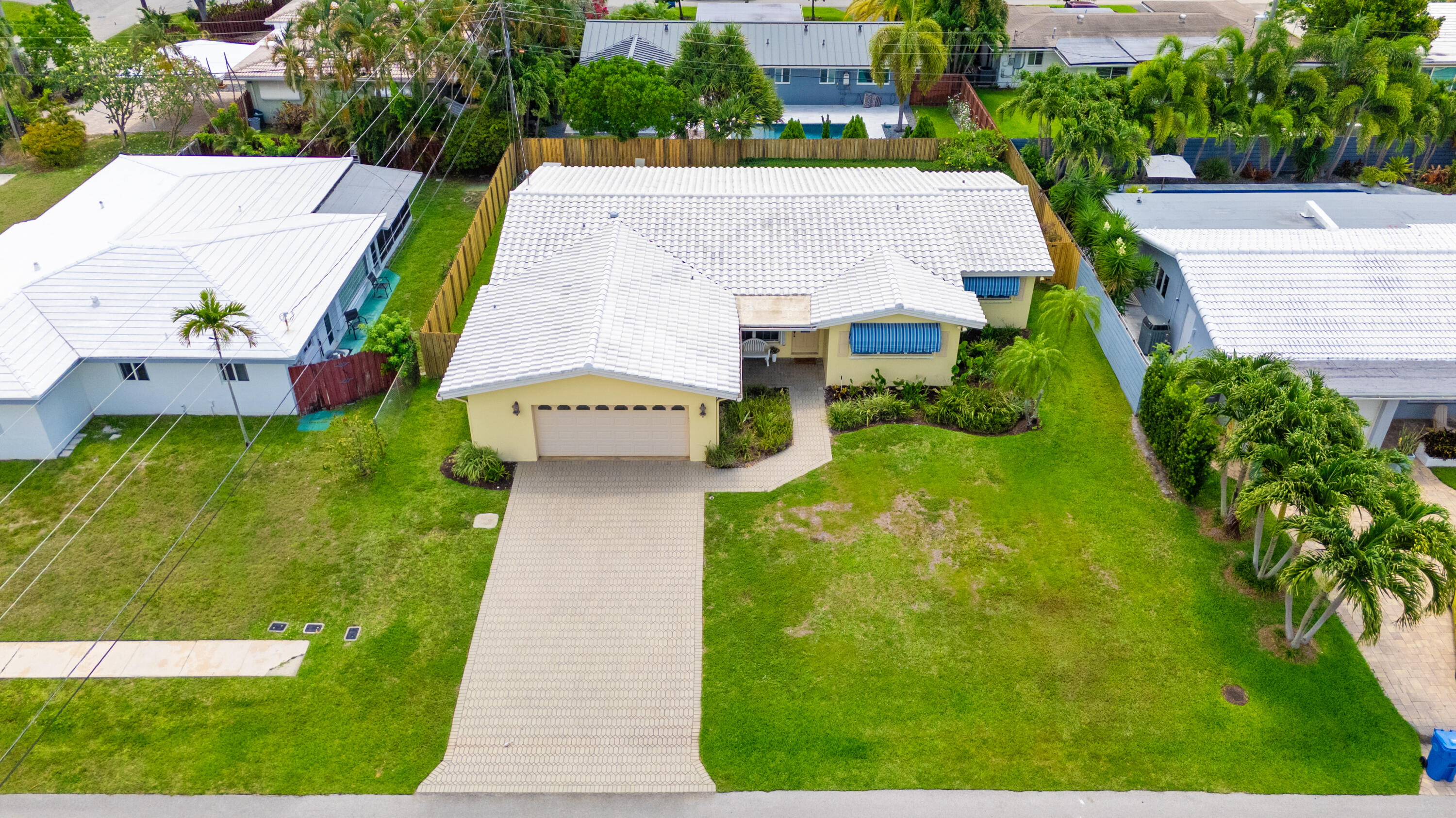 Welcome to this thoughtfully designed single-family residence located in Coral Heights. This one-story home offers 2,179 square feet of finished living space with 4 bedrooms and 3 full bathrooms, providing ample room and flexibility for various needs. This home was expanded for comfort and practicality offering larger bedrooms, additional living space, walk-closets and expanded 2 & 1/2 car garage for additional storage for your family. Full home generator and hurricane protection creates comfort and security.  Splash in the pool in your private backyard completely fenced for privacy. This residence presents an excellent opportunity for those seeking a well-proportioned home in an established community. Located near restaurants, stores and 2 miles to the beaches.    Additional features include: 2nd refrigerator stays, full house generator, security system. Owner states they have 100% hurricane protection. Buyer to obtain a wind mit and 4-point inspection to determine insurance estimates.