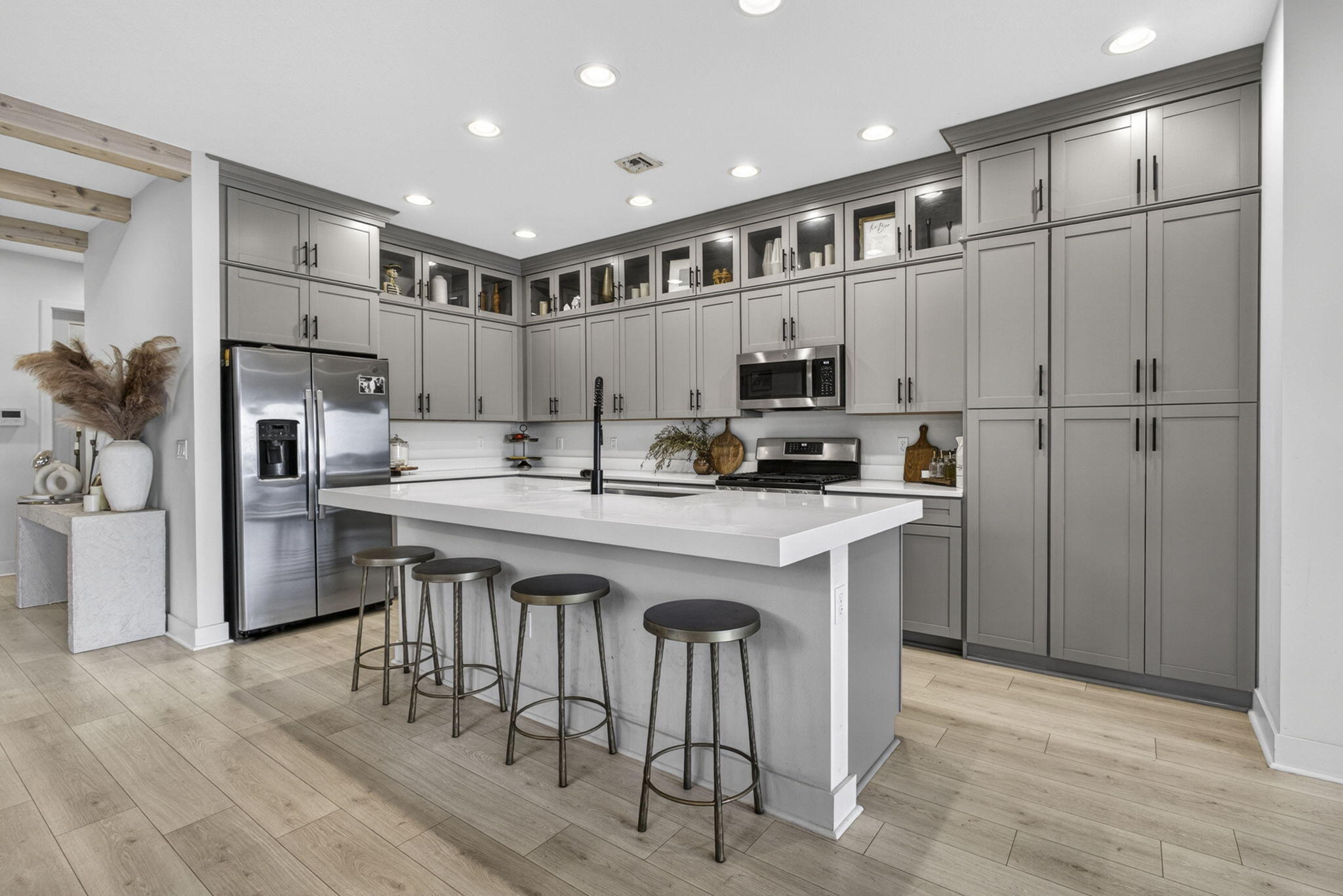 Welcome to this beautiful 4-bedroom, 2.5-bathroom home in Westlake.  Property features premium lot with the longest water-view in Skycove along with nearly every possible builder upgrade. Built in 2022, this home features full impact windows & doors, upgraded 42" kitchen cabinets with museum-style top cabinets, large farm sink, luxury vinyl flooring, rustic wood beams in entry, fenced side & backyard, main bedroom on the first floor with large walk-in closet & custom built-ins, custom shower tiled to ceiling, & double vanity. Enjoy all Westlake amenities: Resort style pool & waterslide, basketball courts, dog park, BMX bike park... Save money on a gym membership as Skycove fitness center is short walk & open 24 hrs. Sellers will sell furnished so buyers can purchase turnkey (see list).  Items willing to be included in purchase: barstools (4) Dining table & dining chairs (6) coffee tables (2)  living room couch Living room side chairs (2) master bed frame (king) upstairs bed frames (2 queen) Flat screen tvs (4) Entry way table Lanai patio furniture Gym equipment in garage Lawn mower, weed eater & hedge trimmer Ice chest freezer in garage