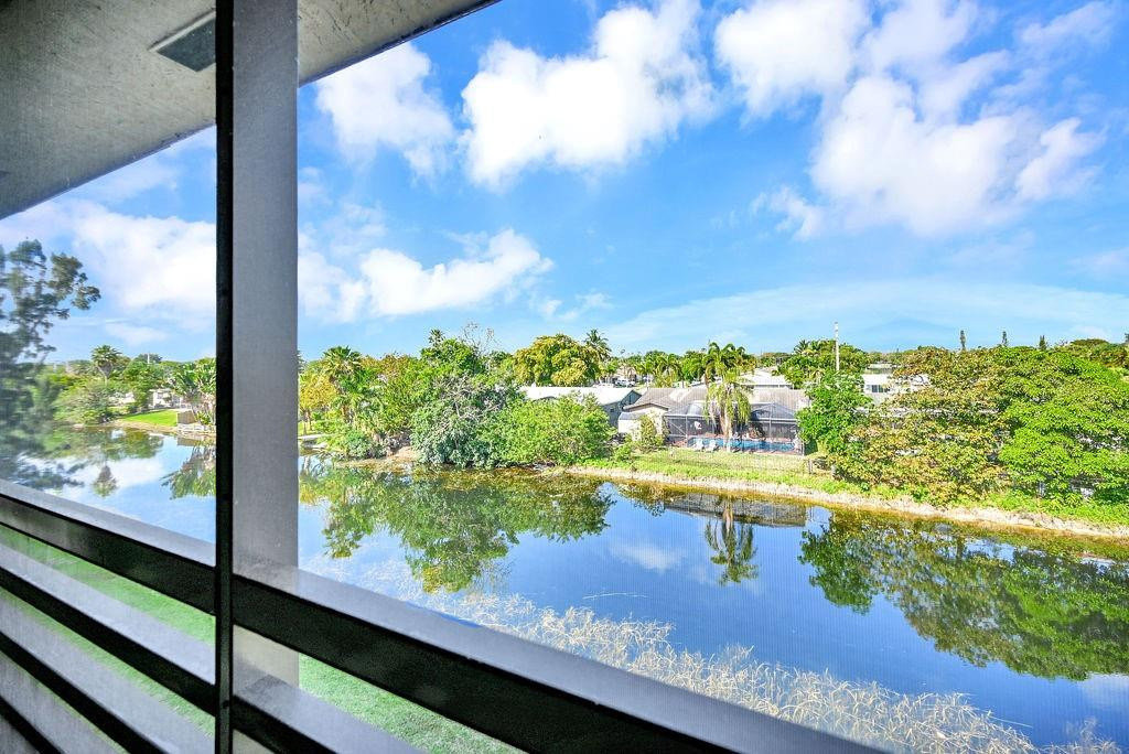 Welcome to this unique 2-bedroom, 2-bathroom corner unit on the 3rd floor, offering serene canal views from your screened balcony—perfect for relaxing and enjoying the tranquil surroundings. The upgraded kitchen features modern finishes, making it a delightful space for cooking and entertaining. The ceramic tile floors throughout the unit add a sleek and low-maintenance touch. Located in the highly desirable 55+ community of Sunrise Lake, residents have access to an abundance of amenities, including a movie theater, courtesy bus, tennis courts, golf, pools, sauna, hot tub, and much more! This unit also includes assigned parking, with plenty of guest parking available. Don't miss your chance to experience comfortable living in a vibrant, active community!
