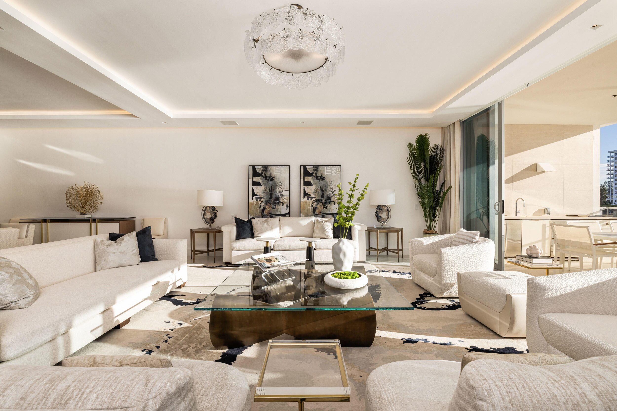 Penthouse 2 at Boca Beach Residences is a rare, fully furnished waterfront offering with sweeping views of Lake Boca and the Atlantic Ocean from every guest suite. This 4-bedroom + den, 3.5-bath residence features a spacious flow-through layout with over 600 square feet of private outdoor space--including two terraces, one with a summer kitchen overlooking the Intracoastal. A private boat slip is included, offering direct access to South Florida's premier waterways. Every detail of this designer-finished residence reflects the essence of elevated coastal living. Wide-plank white oak flooring, floor-to-ceiling glass, custom motorized blinds, outfitted closets, and curated wall coverings create a sophisticated and harmonious interior. The chef's kitchen is appointed with Italian smoked-glass cabinetry and top-of-the-line Gaggenau appliances, including a gas cooktop, wine cooler, and paneled refrigerator/freezer. The primary suite is a true sanctuary, featuring a custom Poliform wardrobe and a spa-inspired bath with dual waterfall vanities and LED-lit mirrors. Each guest suite opens to a private terrace, offering both comfort and seclusion. Located on 3.2 acres of prime lakefront, Boca Beach Residences is an exclusive enclave of just 32 homes directly across from the Boca Raton Resort & Club. Residents enjoy semi-private elevator access, smart-home technology, and boutique amenities including a private marina, lakefront pool and spa, yoga lawn, lakefront boardwalk, Aqua Room for water sports storage, five-star concierge, valet, and private underground garages all surrounded by lush tropical landscaping by Raymond Jungles and architecture by Sieger Suárez. This is waterfront living redefined turnkey, refined, and effortless.