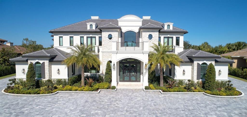 Rarely does a New Estate of this Caliber come to market. Relocation forces sale presenting an Incredible opportunity to own a Perfect Private Entertaining Compound on one of South Florida's Finest Golf Estates lots.  Enjoy sweeping vistas on almost one acre in PGCC. This Gated Custom built Transitional Mansion combines elements of European Grace & Southern Charm with its unique grand covered balconies and stone cladding. Built originally as a generational dream home to far exceed the Strictest Structural Codes and Latest in Smart Home Technology. Inside you'll find a perfect balance of colors and architectural details from its dramatic 2 story Entry Rotunda, Gourmet Kitchen to its incredible Home Theater. Then Bring the outside in at dusk when your smart home knows to lower the screens- then simply slide a wall of glass & set a stage for alfresco dining over looking your lake sized pool, waterfall and fire vessels. Art Imitates Life Here! Available Immediately just bring your toothbrush!