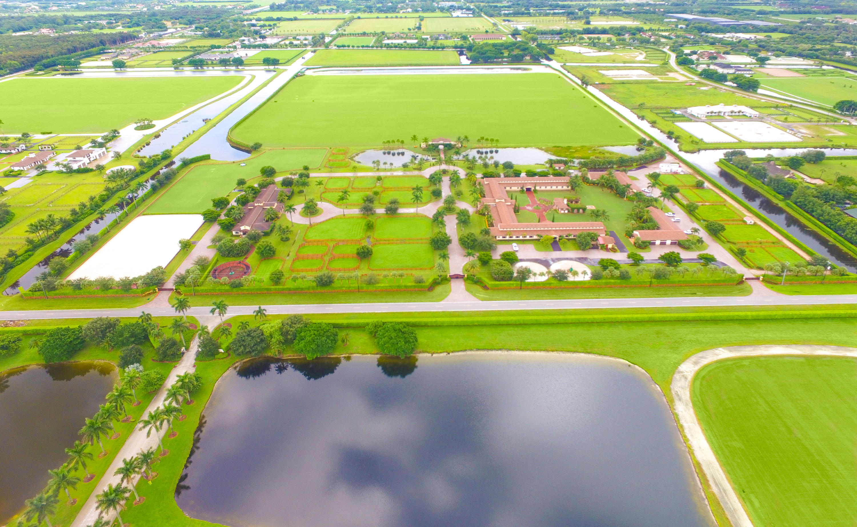 This impeccable 62-acre equestrian compound in heart of Wellington is located within minutes of the Winter Equestrian Festival, Global Dressage Festival, and International Polo Club. Completed in 2005 with top notch facilities for Hunter/Jumper and Polo activities this farm is ready for occupancy.The polo area barn is shaped as a square with 20 stalls in each row for a total of 60 stalls centered around a courtyard with sitting area, summer kitchen and Asado grill. In close proximation are 2 regulation size Polo fields with 1/4 mile exercise track. Celebration Grassland and a grandstand with fitness center & bathrooms. Additional features include 6 tack rooms, 4 feed rooms, wet fly spraying system and aquatic horse walker. For your daily needs the facility includes industrial ADC washer/ dryers.Onsite living quarters for the owner with outdoor terrace and staff area accommodate. 9 apartments with a central kitchen and laundry. Manager's area includes main office with 2 suites, 1 includes storage room for polo side boards, wash racks and 2 sets of conference rooms, 2 bathrooms, laundry area, 1 small separate office. Additional facility attributes include showroom with bathroom, massage cottage, conference room with kitchen, bathroom pantry area.The hunter/ jumper area includes 12-stall barn, 2 feed rooms, 4 wash rooms, 160" x 255" sand ring, 160" x 255" Grand Prix grass ring, three 4- 6 horse walkers, 4 paddocks. A conference room, 1 guest room and 4- staff apartments complete all catering needs.High end car collectors garage.