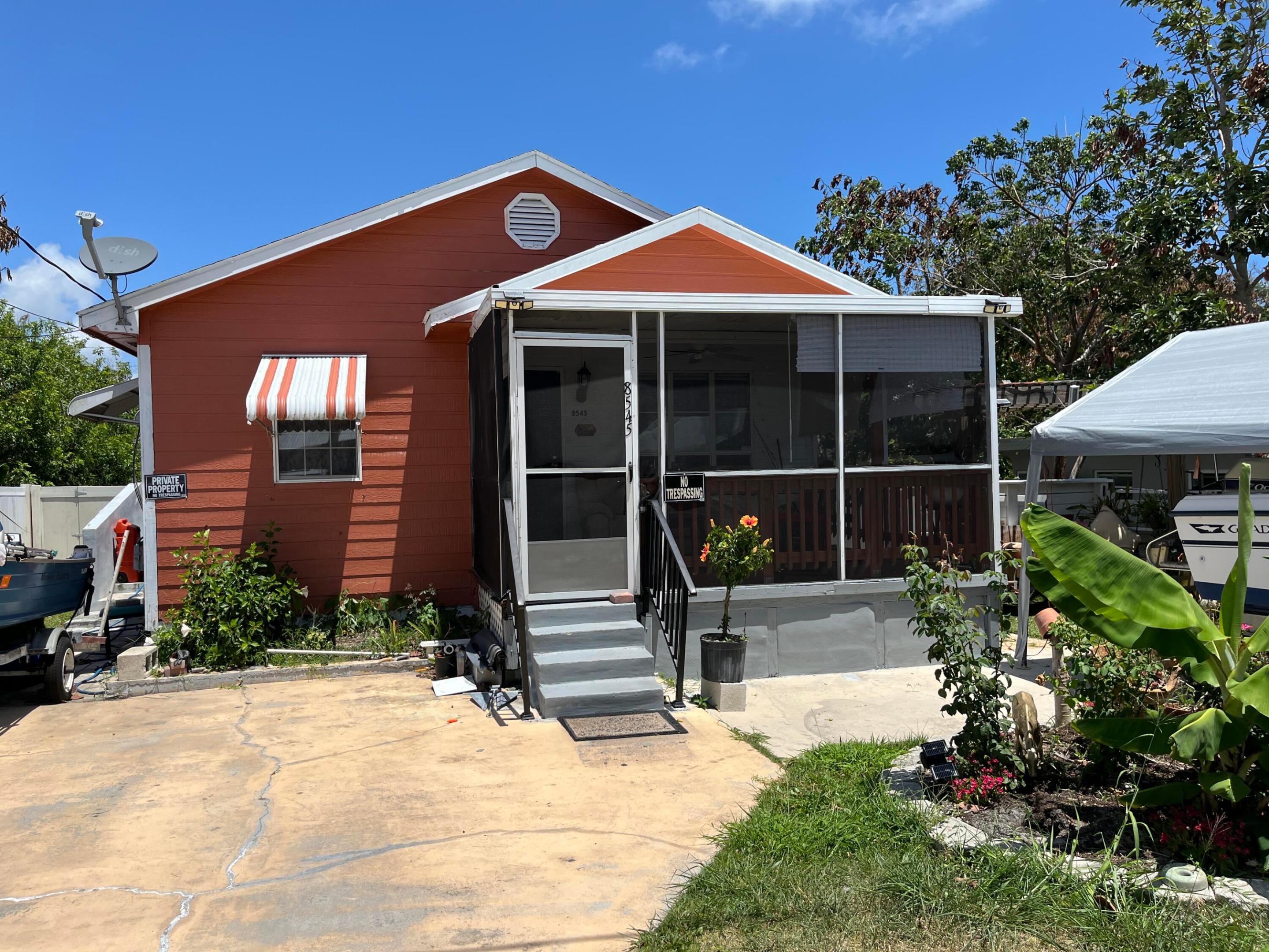 MOVE IN READY 3 BED 2 BATH IN HOPE SOUND.   Vinyl flooring and tile throughout.   Screened Front Porch. and large back porch.  Room for boat or camper.   Chicken coop on property as well.   Don't miss out on this excellent opportunity, to own a great home in Hobe Sound.  Minutes  to Intracoastal and oceanside.  Walking distance to shopping & new publix.   NO HOA .  Don't Wait. Some photos are Virtually staged.