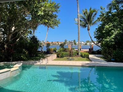 Presenting a lushly landscaped residence on the Intracoastal front featuring 5 Bedrooms, 5 1/2 Baths, plus a separate Gym/Studio, newer Dock & Sea Wall, full house Generator, Impact Glass and Pool/Spa (heated). As you pull into the white gated picket fence entry drive lined with Chicago Brick, you are immediately transported to a secluded ''Magical Paradise'' that calms and soothes. Sited on an estate sized lot measuring approx. 200' deep and 71' on the water, this home has commanding water views and private outdoor patio & garden areas to rival any local Plant/Tree Nursery. The interior features large open spaces and rooms finished with wood/tiled floors. Come enjoy the relaxing and tropical grounds and pool area of this updated home or meander to the Avenue or Beach for the day. see more All Bedrooms are ensuite plus a powder room. Built in book cases, a kitchen that opens to the Family Room, 2 Master Suites and a large Pantry/Laundry room are just a few of the features of this home. Remodeled and basically rebuilt and updated in 2011, this home will not disappoint the most discriminating Buyer. Freshly painted inside and out in August 2021.Many other features that are too numerous to mention here. Property is located in the Marina Historic District. Please be sure to view the attached Floorplans and call soon to make this your new Delray Beach home!