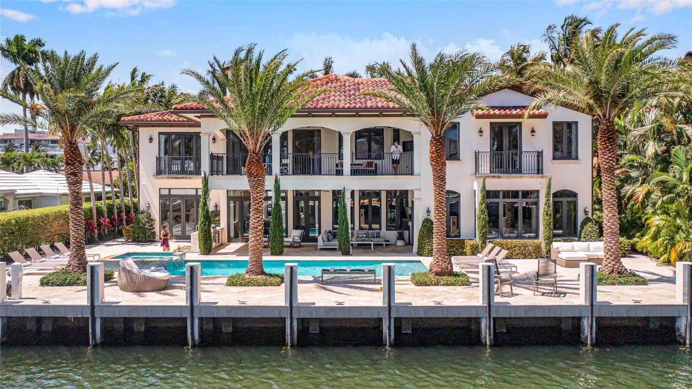 Stunning transitional deepwater estate on 95 feet of prime Las Olas waterage with eastern exposure. Turnkey and ready for immediate occupancy. Resort caliber grounds feature pool, spa, and summer kitchen overlooking the water. Professionally designed coastal interiors deliver sophisticated entertaining spaces throughout. Two-story living room with fireplace flows to formal dining, expansive great room, and waterfront chef's kitchen with premium appointments. Dual laundry rooms, custom lighting and window treatments throughout. Grand staircase and elevator to four generous bedroom suites. Spectacular primary retreat features a sitting area, spa-inspired bath, custom-fitted closets, and a private covered balcony commanding water views. This is Las Olas waterfront living at its finest.