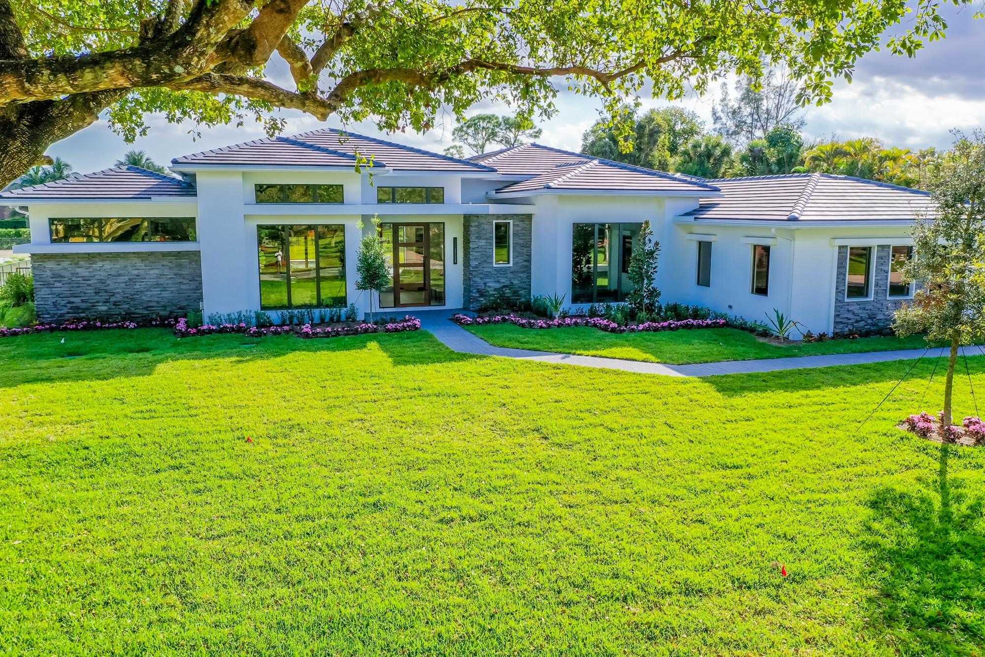 Setting the bar for luxury & elegance in one of the most coveted neighborhoods in Palm Beach Gardens. Spanning nearly 5,000 square feet of pure perfection, this trophy home is in a league of its own, achieving unparalleled scale and quality. The attention to detail, seamless flow throughout and vast nature is realized upon the moment of entry. Sleek back sliders vanish, offering the most dramatic indoor/outdoor living imagined with the most impeccable views of your 1 + acre private backyard and lavish resort style pool. Exuding sophistication and style, this 5 bedroom, 6 bathroom home + Office + Gym and flex space includes massive 15 foot ceilings, a state of the art kitchen with top of the line Sub Zero and Wolf appliances, plus an outdoor summer kitchen with tons of covered patio space.