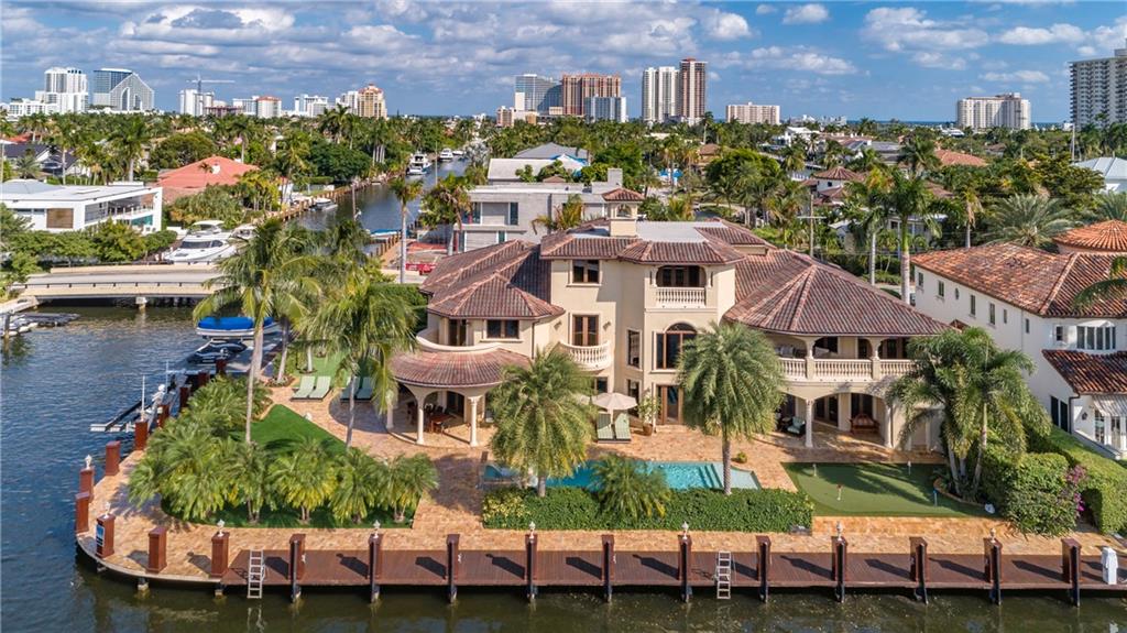 Magnificent custom home on an interior point lot w/264' of water frontage! Incredible finishes & highest quality construction. The light & bright floor plan is perfect for entertaining. Outstanding design elements of the home include tray ceilings, wet bar, rich Brazilian cherry wood to warm the bedrooms, large gourmet kitchen, 2 sided fireplace, theater room & 3rd level game room. Features include mosquito misters, elevator, putting green, full house generator & sound system. Over-sized master suite w/morning bar, walk-in closet & luxurious master bath w/dual sinks. Resort-style pool & backyard. 20,000lb boat lift & 20,000lb no profile lift. Quick & easy ocean access. Fantastic Seven Isles location, quick walk or bike ride the beach, fine dining & nightlife.