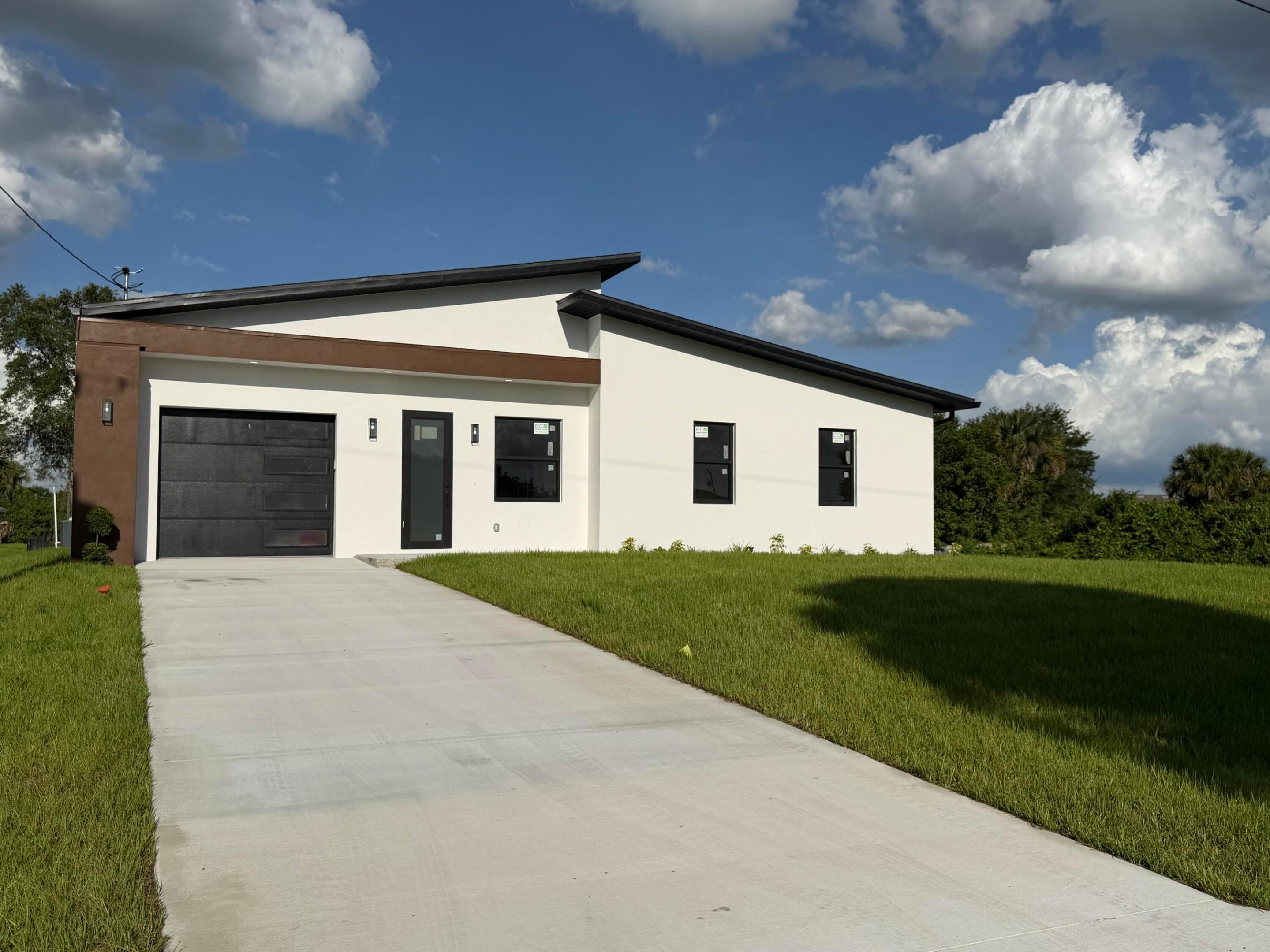 Welcome to this spectacular brand new construction featuring a modern design and high-quality finishes throughout. This home offers 10-foot ceilings, creating a bright and open living apace, complemented by elegant ceramic title flooring. The kitchen showcases luxury finishes, along with beautiful upgraded bathrooms that reflect the same level of detail and style. All windows are impact-resistant, providing added security and peace of mind. A unique highlight of the property is a full bathroom located just behind the garage, offering great potential to be converted into an efficiency or private guest space. Don't miss the opportunity to own this thoughtfully designed home on a growing are of Lehigh Acres.