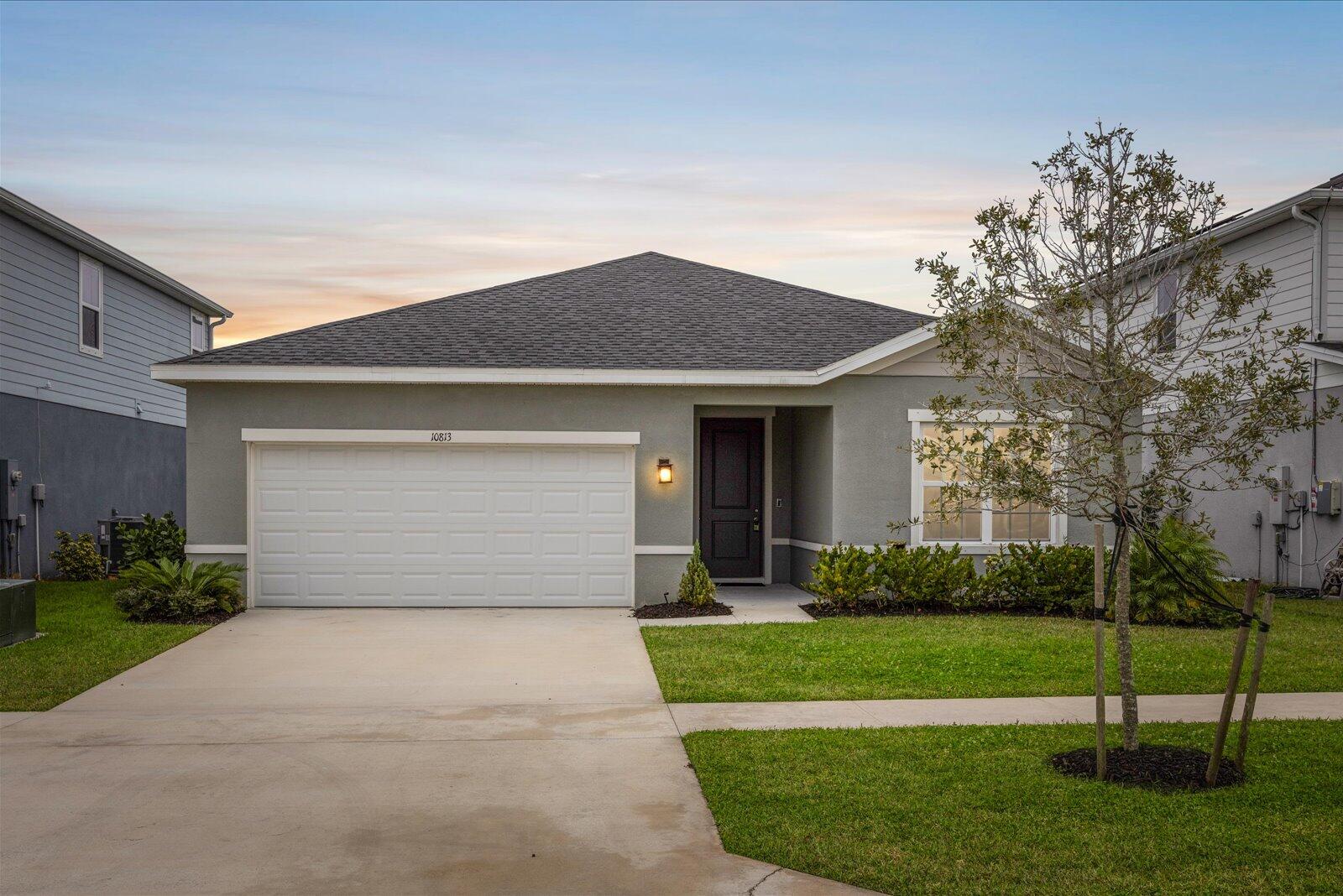 One of the LOWEST HOA's in 34987! Built in 2022, this well-maintained 3-bedroom, 2-bath home offers modern living with a peaceful lake view and an incredibly low HOA of approximately $30 per month. The open-concept layout features a bright living space that flows into the kitchen and dining area, ideal for everyday living and entertaining. The split floor plan provides privacy, with a spacious primary suite and two additional bedrooms perfect for guests, a home office. Enjoy serene water views from the backyard along with newer construction, modern finishes, and energy-efficient features. Most importantly, all in a convenient location near Tradition, shopping, dining, and major roadways.