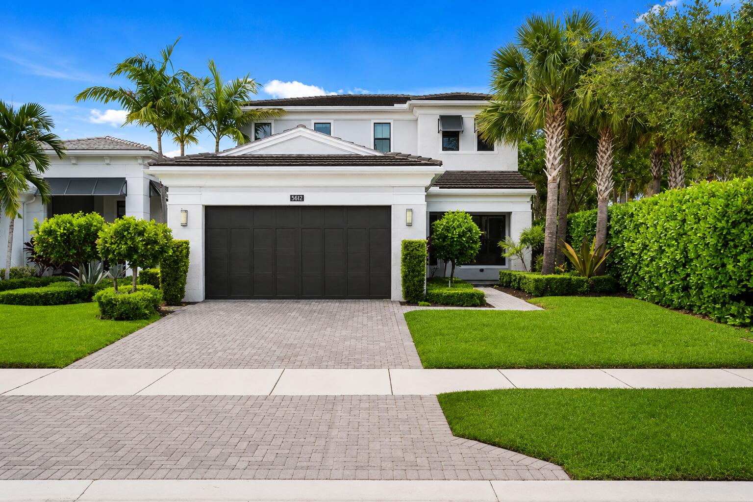 This modern & bright Francesca model is located in the BEST corner lot in one of Palm Beach Gardens' most sought-after newer communities: ARTISTRY! This beautifully upgraded & freshly painted (interior & exterior) residence offers 3,155 square feet of living space with 3 bedrooms plus a spacious loft, 3.1 bathrooms, 2 car garage and a thoughtfully designed floor plan featuring the primary suite on the main level.  The main-floor primary retreat includes a custom organized walk-in closet, built in electric fireplace and a large ensuite bath with a new vanity, a soaking tub, and a separate walk-in shower. The main level also features a conveniently located laundry room, elegant white tile floors, custom wood trim & finishes, and stylish new fans & fixtures throughout. The spacious kitchen is designed for both everyday living and entertaining, offering sleek white cabinetry, stainless steel appliances including a gas stove, elegant backsplash, quartz countertops, a breakfast area, and seamless flow into the dining area and separate living space. Large impact windows and doors fill the home with natural light, while the living area opens to a covered lanai and private backyard. Upstairs, a newly finished wood staircase leads to the second level, featuring new wood floors, a generous loft, and additional 2 bedrooms with no carpet throughout. The fully fenced backyard has been newly finished with turf grass and enhanced with private landscaping, creating a low-maintenance outdoor space ideal for relaxing, entertaining, or enjoying the South Florida lifestyle. With all impact windows and doors, a brand-new water heater, modern finishes, a flexible layout, and a prime Palm Beach Gardens location close to the best beaches, restaurants, & shopping malls; this Francesca Model offers the perfect blend of luxury, comfort, and convenience.