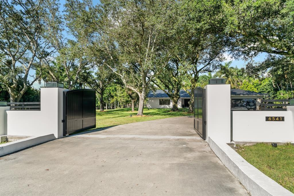 BUILD your Custom Home on the most beautiful lot in Southwest Ranches! This exceptional 3.25-acre corner lot, perfectly positioned at Melaleuca Road and Luray Road, offers a perfect canvas for your dream estate. Enter through a private, gated entrance framed by majestic mature oaks, setting the tone for the exclusivity. Located in Broward County’s most coveted and fastest-growing luxury enclave—home to elite athletes, entertainers, and top-tier executives. Unlike most parcels in the area, this property has been upgraded with city water access—saving time and expense. Architectural and engineering plans for a custom estate are available to qualified purchasers.