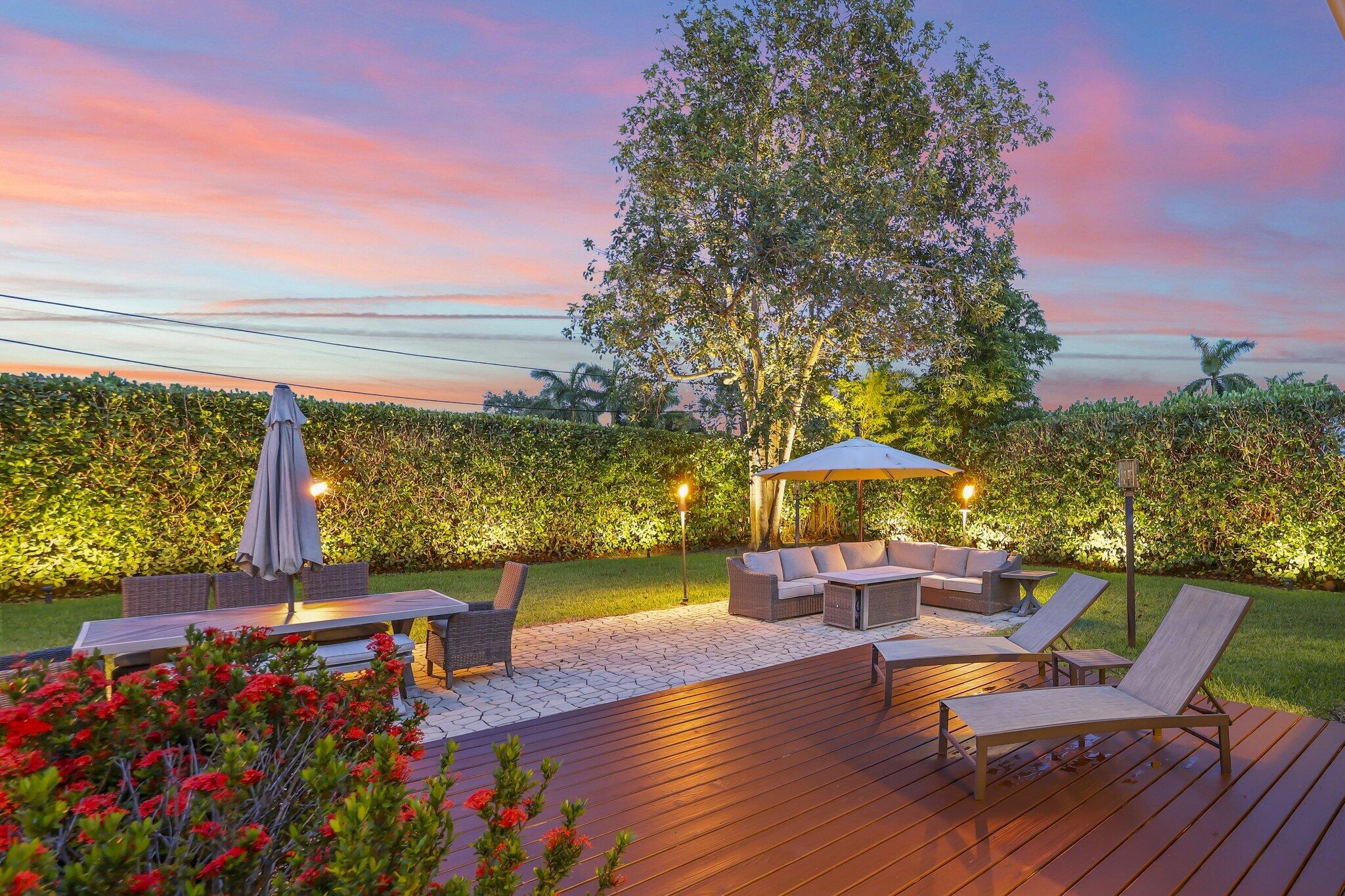 Welcome to 2205 W Pineridge Ct, a beautifully updated 2-bedroom, 1-bathroom home in the heart of Delray Beach, set on a nearly 9,000-square-foot lot at the end of a quiet cul-de-sac with virtually no through traffic. Tucked behind lush clusia hedges and podocarpus, the property offers exceptional privacy while still being just a golf cart ride from Atlantic Avenue, the beach, and Atha Yoga.    This approximately 1,000-square-foot home has been thoughtfully renovated with updated plumbing and electric, all-impact windows and doors, and luxury vinyl flooring throughout. The exterior was recently repainted and paired with a brand-new, weather-resistant deck, along with updated landscape lighting that highlights the mature grounds, including a large avocado tree. Because the home is on a well  that also feeds the irrigation system, owners benefit from notably low water bills.  The bathroom features a combination tub/shower with jacuzzi jets and a window overlooking the private backyard. Additional highlights include a brand-new Bosch refrigerator and brand-new Samsung washer and dryer, an exterior shed for extra storage, and a versatile enclosed, screened-in carport that can be converted back to traditional car port use or enjoyed as an outdoor living space.  With its prime Delray Beach location, move-in-ready updates, and flexible layout, 2205 W Pineridge Ct is ideal for a young family or an investor looking to capitalize on the home's strong Airbnb potential.