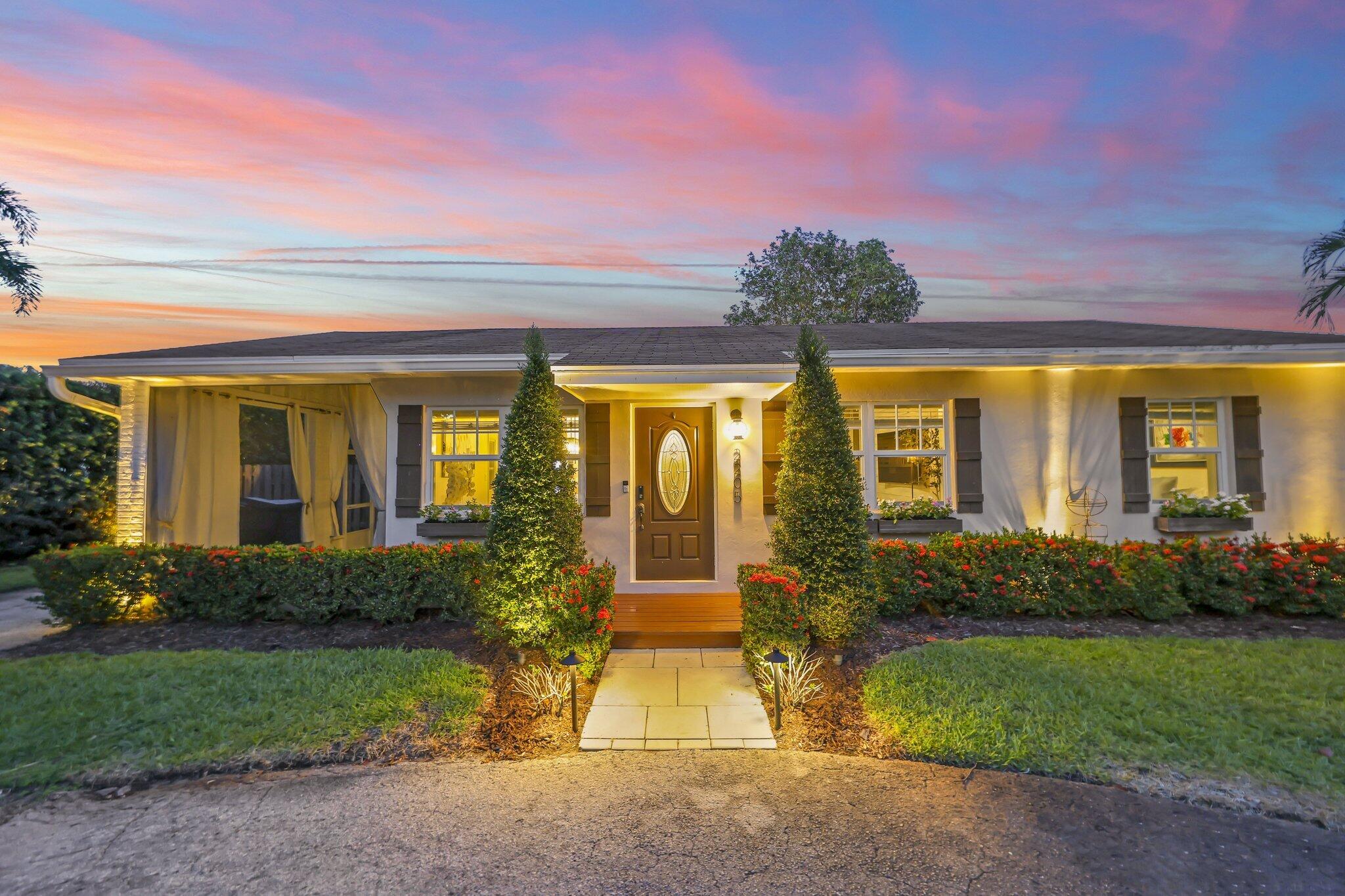 Welcome to 2205 W Pineridge Ct, a beautifully updated 2-bedroom, 1-bathroom home in the heart of Delray Beach, set on a nearly 9,000-square-foot lot at the end of a quiet cul-de-sac with virtually no through traffic. Tucked behind lush clusia hedges and podocarpus, the property offers exceptional privacy while still being just a golf cart ride from Atlantic Avenue, the beach, and Atha Yoga.    This approximately 1,000-square-foot home has been thoughtfully renovated with updated plumbing and electric, all-impact windows and doors, and luxury vinyl flooring throughout. The exterior was recently repainted and paired with a brand-new, weather-resistant deck, along with updated landscape lighting that highlights the mature grounds, including a large avocado tree. Because the home is on a well  that also feeds the irrigation system, owners benefit from notably low water bills.  The bathroom features a combination tub/shower with jacuzzi jets and a window overlooking the private backyard. Additional highlights include a brand-new Bosch refrigerator and brand-new Samsung washer and dryer, an exterior shed for extra storage, and a versatile enclosed, screened-in carport that can be converted back to traditional car port use or enjoyed as an outdoor living space.  With its prime Delray Beach location, move-in-ready updates, and flexible layout, 2205 W Pineridge Ct is ideal for a young family or an investor looking to capitalize on the home's strong Airbnb potential.
