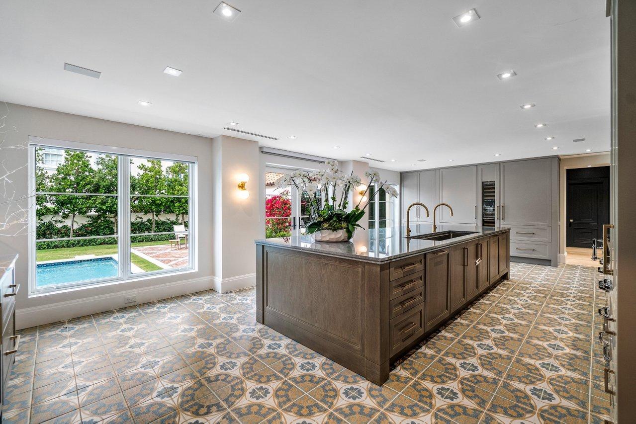 Newly custom renovated 5 bedroom home with downstairs master suite in the prized Estate Section. Totally transformed to today's active living, this light and bright home has well scaled living areas with high ceilings and a fabulously landscaped, oversized pool/patio area perfect for entertaining. Its multiple amenities include:  original Cuban tile entry foyer and hardwood floors, a true state of the art kitchen and bar with a Viking Tuscany stove, impact resistant glass, tandem 2 car garage, and much more! This home was the tea pavilion for the historic Woolworth Estate built in the 1920's.
