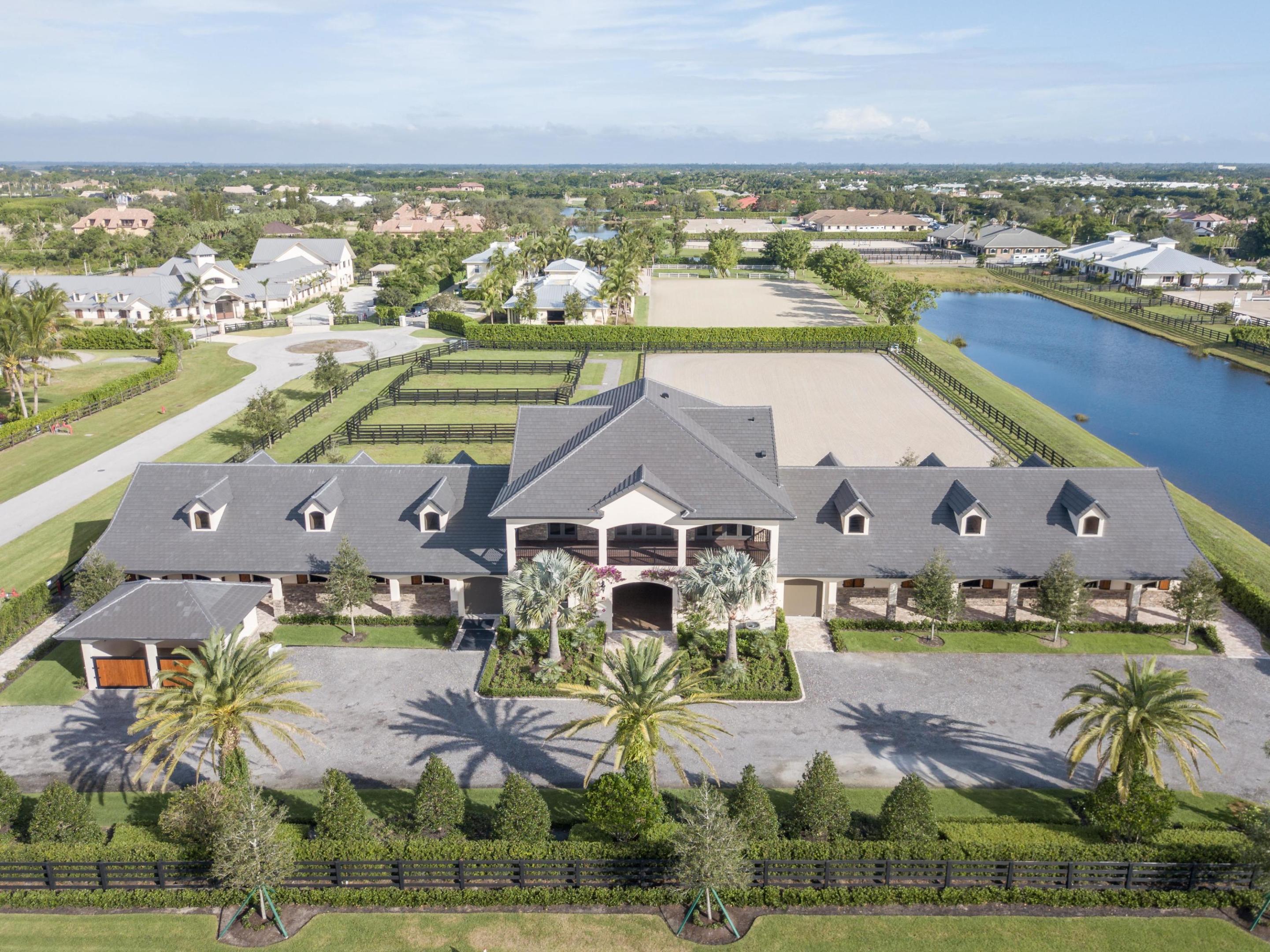 Exquisite new construction in the beautiful Grand Prix Village South neighborhood situated on 4 acres of well maintained land. This property was planned to be every equestrian's dream. The 20-stall center aisle barn is fresh and functional with four wash stalls, tack and feed rooms, a laundry room, an office, lounge, and a full bath. The second story of the barn serves as a refined space for relaxation. The owners' quarters include three bedrooms, three bathrooms, an open kitchen, and spacious living areas. The wrap around porch is not to be missed - nor are the breathtaking views of the property. The grounds include 4 paddocks and a sand arena. Close to PBIEC, this immaculate property is move-in ready for season. Be sure not to miss this truly unique custom barn by designer Joyce Bashein.