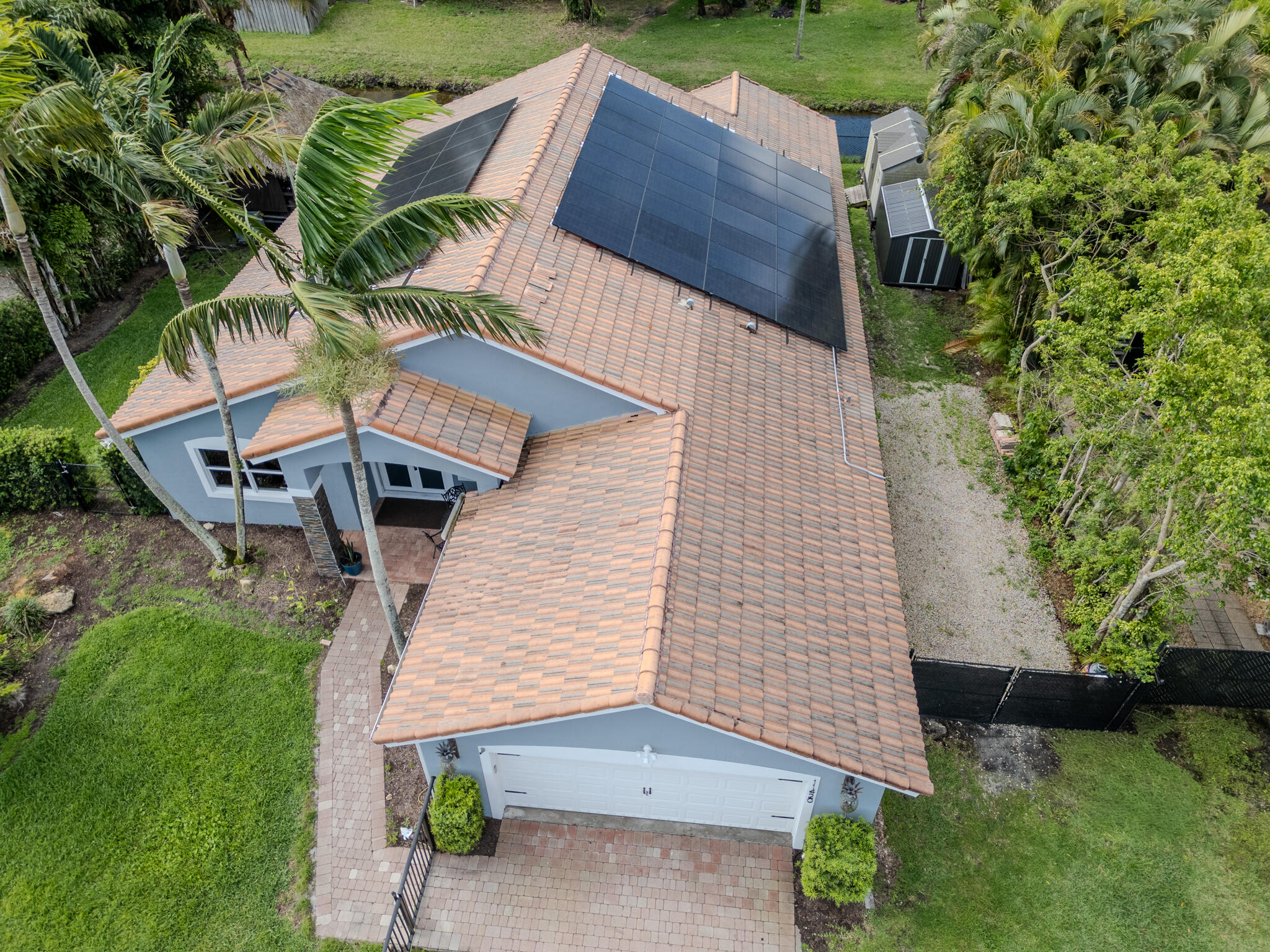 A Peaceful Waterfront Haven in Plantation Acres Step into a home that feels like a deep breath. Tucked away in the quiet of Plantation Acres, this 4-bedroom plus den sanctuary offers a rare blend of modern refinement and soulful warmth. The heart of the home is a sun-drenched kitchen with gas cooking and a wine cooler, perfectly designed for slow mornings and shared meals. Retreat to spa-like bathrooms or step outside to your private waterfront oasis. The heated salt-water pool and spacious tiki-hut create a vacation-like atmosphere every day. Enjoy total peace of mind with full impact windows, and fresh exterior paint. This is a worry-free haven on a lush 0.29-acre lot with no HOA. Truly turn-key KITCHEN, BATHROOMS, POOL, FLOORS All done within a few years!!!