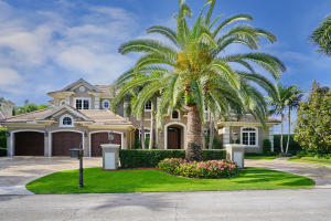 Stunning golf course home in Royal Palm Yacht & Country Club with five bedrooms, five full and two half bathrooms, and almost 6,500 sqft under air. Great outdoor area with huge backyard, free throw basketball half court, lush tropical landscaping, heated pool with sun shelf and cascading spa, marble paver patio, summer kitchen, covered patio with fireplace, and chipping green right behind the property. This custom home features all natural gas, 3-zone air conditioning, Crestron system for music and a three car garage plus golf cart. Wood flooring throughout all main living areas, office/den, clubroom with bar, large family room off the kitchen, mud room with cubbies and storage, first floor guest suite, second floor loft area. Gourmet kitchen has granite countertops, custom wood cabinetry, large center work island with vegetable sink, bar seating, desk area, top-of-the-line appliances including Thermador range with six gas burners, griddle and two ovens, Thermador wall oven, warming drawer and microwave, Kitchen Aide refrigerator/freezer and two dishwashers, large walk-in pantry with built-in shelving, second refrigerator, washer and dryer. Large second floor laundry room with washer, dryer, sink, drip station and storage. Spacious second floor master suite with breakfast bar, French doors leading to balcony, large his and her walk-in closets, exercise room/sitting room, and large bathroom with his and her sinks, vanity area, granite countertops, custom cabinetry, private water closet, spa tub and large walk-in shower with two shower heads plus rain shower.