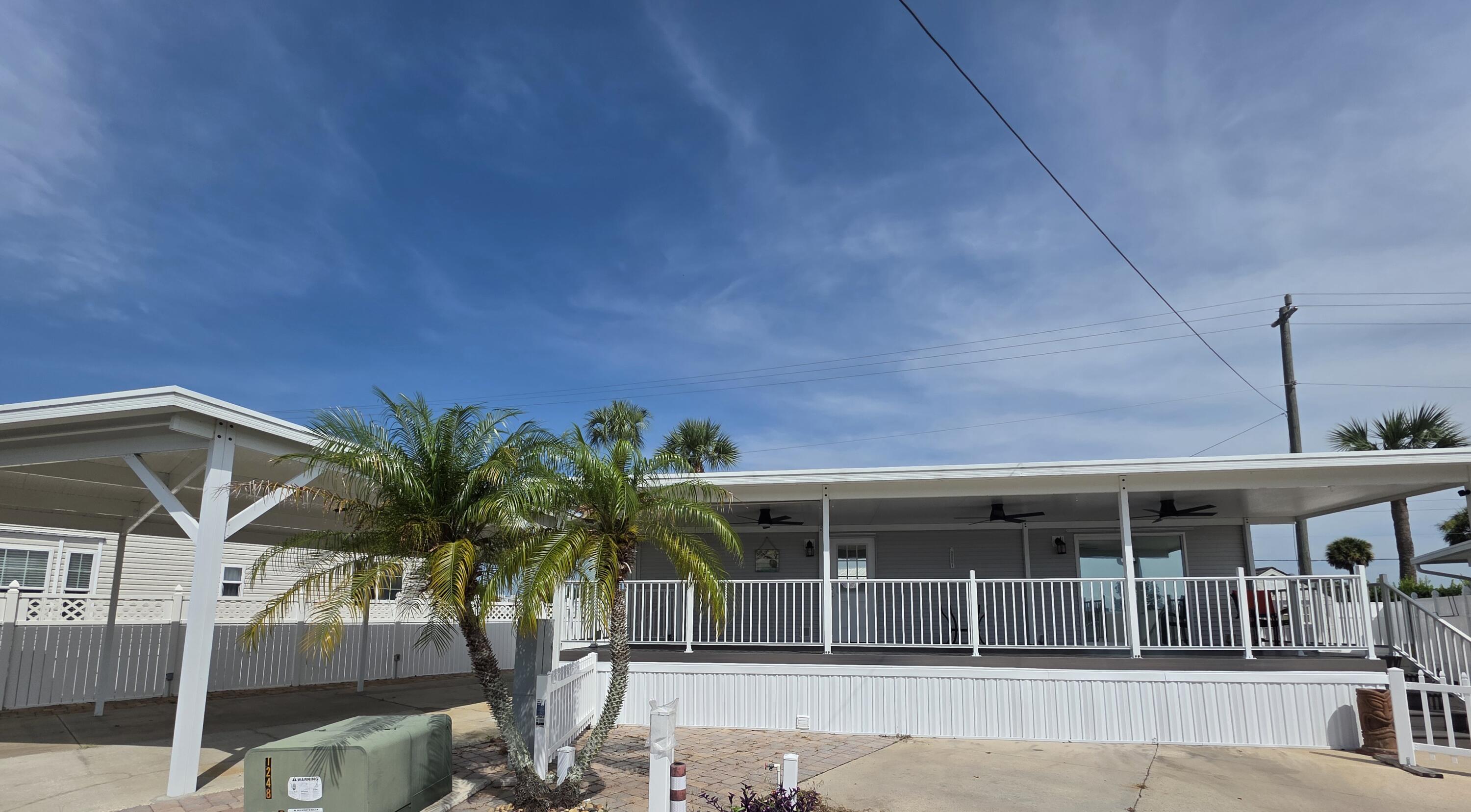 BIG O RV RESORT Gorgeous 2019 Palm Harbor model. This beautiful unit is on 2 lots with paved driveway and a 23x33 carport. Large 12x36 porch made with composite decking. The inside features high ceilings, large walking shower, open kitchen with lots of cabinetry. So many extras and upgrades to this unit. Outside features privacy fencing, and a paver retaining wall. Located right across from the community clubhouse and heated pool. This vast community features a boat ramp and Lake Okeechobee access. Lots of activities including shuffleboard, bocce, and pool table. Hoa includes water, sewer and trash. Minutes away from the city and all the shopping and dining.
