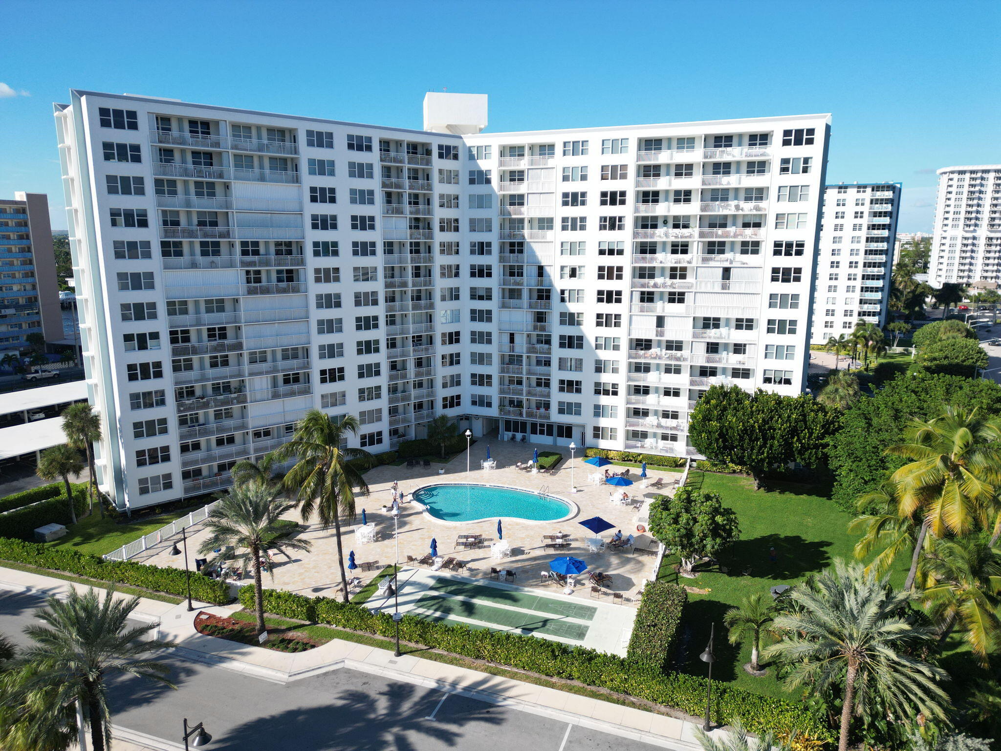 Experience the best of South Florida coastal living in this beautifully updated and meticulously maintained 2-bedroom, 2-bath condominium. Perfectly situated just one block from the Fisher Family Pier, you'll enjoy easy access to waterfront dining, boutique shopping, and Pompano Beach's lively beachfront. Just one block in the opposite direction is the Intracoastal Waterway taxi stop, making it easy to explore the area by boat. Filled with natural light, this inviting residence features an expansive front window and an oversized private balcony overlooking the sparkling pool and beautifully landscaped, park-like grounds while enjoying refreshing ocean breezes. Inside, a spacious closet has been thoughtfully transformed into a functional home office. Recent improvements include a newer A/C  system, newer water heater, new refrigerator, and all-new impact windows and doors. Community amenities include a heated pool, recently resurfaced pool deck with terracotta tile, shuffleboard courts, BBQ area, and new poolside tables and chairs. The building completed concrete restoration in 2024, installed a new fire alarm system, added a backup generator, and successfully passed a recent electrical inspection. Parking lot resurfacing is fully funded through reserves and scheduled for Summer 2026. Rentals are permitted after two years of ownership with a two-month minimum lease. Move-in ready and offered with negotiable furnishings, this exceptional residence is the perfect opportunity to embrace a relaxed beachside lifestyle in one of South Florida's most desirable locations.