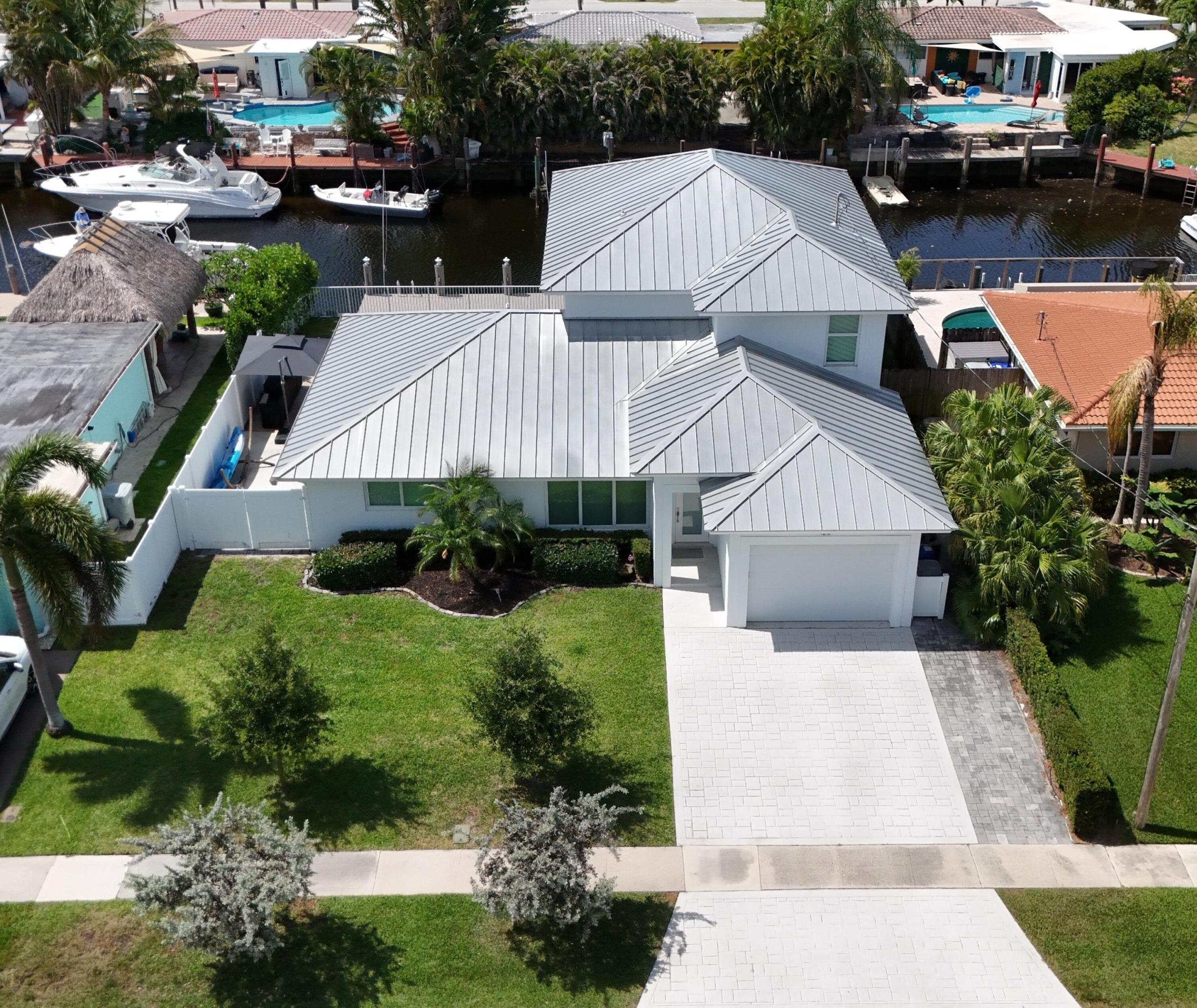 DON'T MISS THIS IMMACULATE HOME BUILT BY LUXURY CUSTOM HOME BUILDER ONLY MINUTES TO PINE CREST SCHOOL AND CLOSE TO BEACH. NEW SALTWATER POOL WITH HEATER AND CHILLER BUILT 2 YEARS AGO. FEATURES 70' WATERFRONTAGE WITH OCEAN ACCESS. 9 1/2' CEILINGS UPSTAIRS. 4 BED 3 BATH OPEN KITCHEN FLOOR PLAN & 12' WIDE ONE CAR GARAGE WITH 10' CEILING. SOUTHEAST EXPOSURE WATERFRONT VIEWS FROM MULTIPLE BEDROOMS, KITCHEN, BREAKFAST, FLORIDA AND LIVING ROOM. NEW IMPACT DOORS AND WINDOWS, METAL ROOF, UPDATED 3 YEARS AGO: NEW AC, NEW AND UPDATED ELECTRIC & PVC PLUMBING ABOVE GROUND AND BELOW, NEW APPLIANCES, NEW DESIGNER CUSTOM KITCHEN WITH ISLAND, NEW FLOORS THROUGHOUT THE ENTIRE HOME. DOCK WITH NEW BOAT LIFT 17,000 LB CAPACITY AND NEW COMPOSITE DECK.