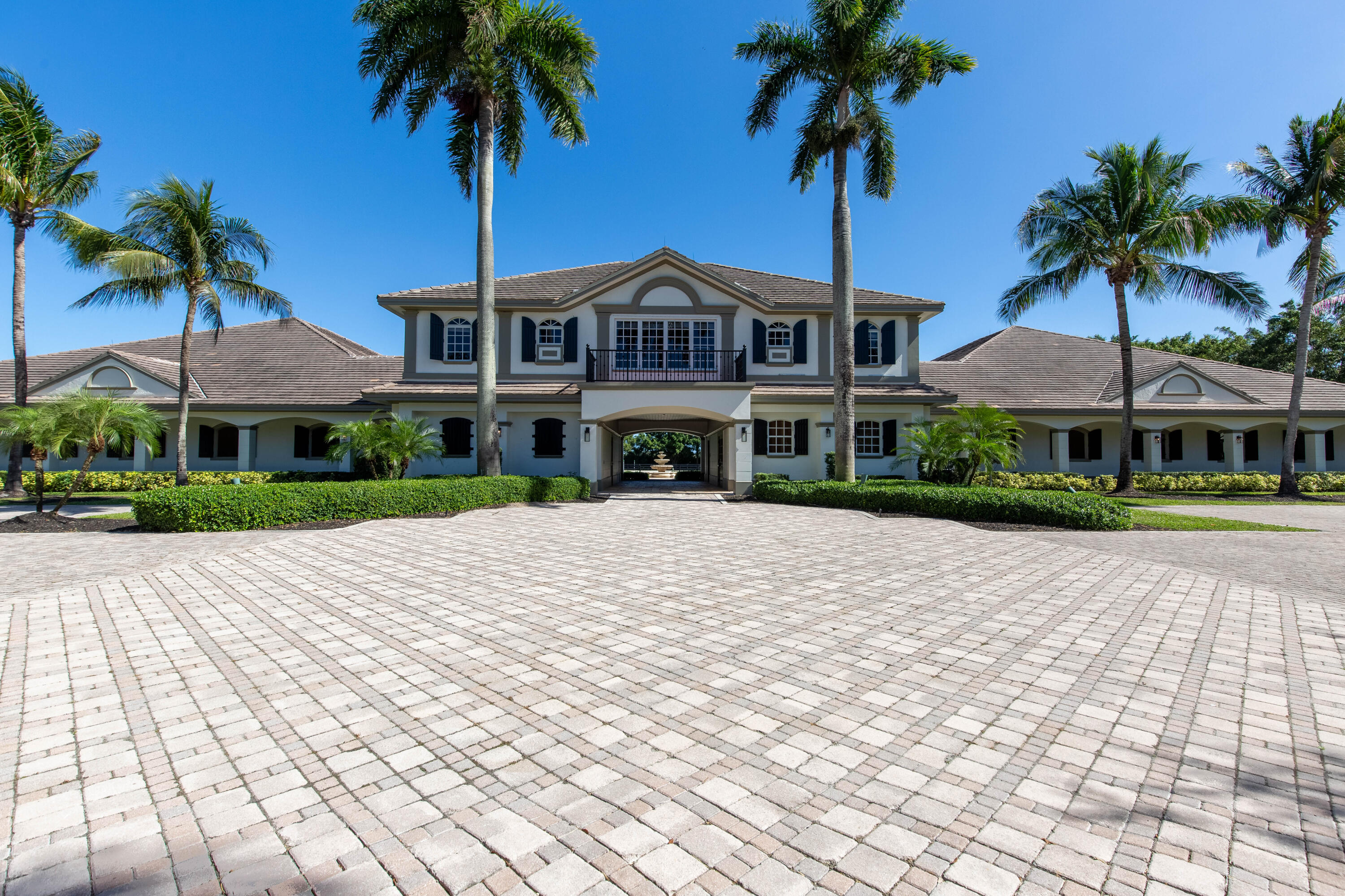 This stunning 5+ acre private equestrian facility is located in the exclusive gated community of Grand Prix Farms of the Equestrian Club. The luxurious property caters to the elite professional, boasting a beautiful 24-stall barn, plenty of paddock space and a large GGT arena. The magnificent barn features a 20x20 office with a half bath, a two bedroom/one bath grooms quarters, Stone-London stall system, two tack rooms, two feed rooms, laundry room and a second floor two bedroom/two bath owners suite.