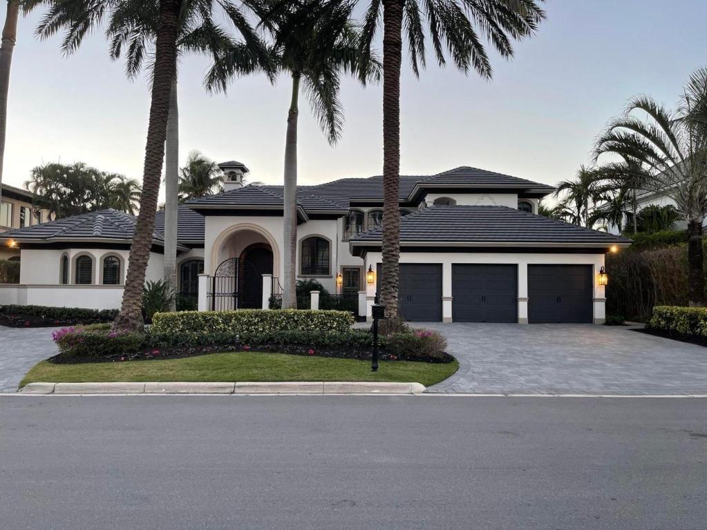 1655 Royal Palm Way is a newly renovated home built  by SRD construction located on the 6th hole of the signature Jack Nicklaus golf course within Royal Palm Yacht & Country Club with beautiful golf and lake views. (Membership not included and separate process.) This home has 4 spacious bedrooms, 4 full baths and 2 half baths. West exposure in the backyard with a lavish pool area, spa, waterfall feature with 3 newly installed LED lights and pool pump. Spectacular sunsets! Other features include: 1st floor Master Suite with his and her baths, 1st floor laundry and 3 car spacious garage. sleek flat tile roof installed in 2020, newly painted light and neutral  inside and outside and Tremron tumbled stone pavers with expansive circular driveway. Kitchen updated in 2020 with stylish Calcutta marble countertop, Viking gas stove, Sub-zero refrigerator, Viking dishwasher and Viking ice maker. Beautifully renovated, modern lighting inside and outside the entire house. Home boasts wide plank solid wood white oak floors downstairs, plantation shutters, and hurricane impact windows throughout. Recently installed hurricane impact garage doors with quiet openers and Epoxy floors. This stunning SRD home is a model home and a show stopper. Too many renovations to list. ALL AC units replaced in 2021. Call to arrange a showing of this spectacular, move-in ready home.