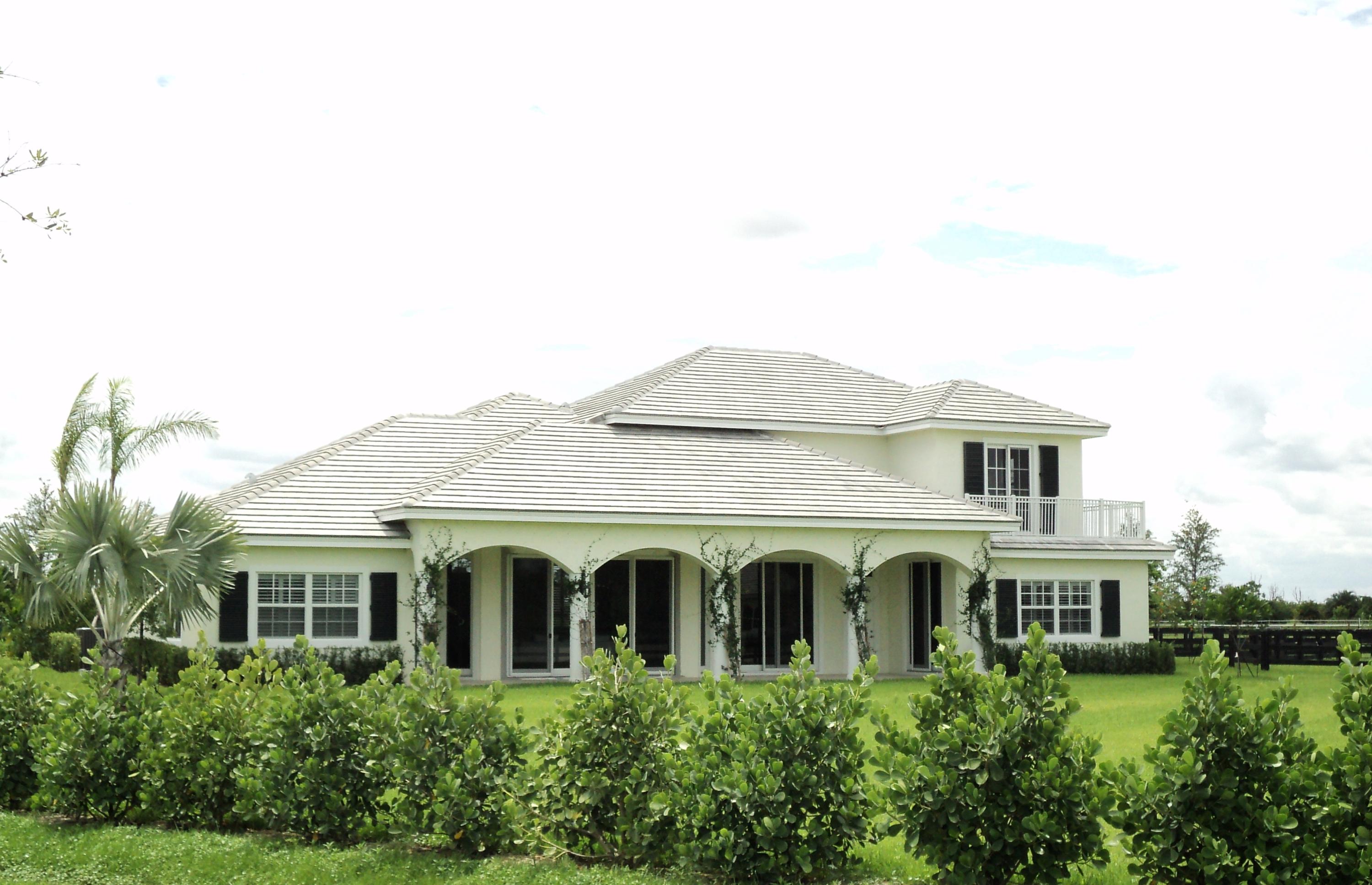New construction - ready for occupancy!Custom built 2 story estate home with 4 bedroom , 3.5 bath and a detached 1/1 guest suite. Home features marble & wood floors ,double ovens, spacious loft living area on upper level and a large covered patio.18 stall barn with 2 grooms apartments ,4 grooming stalls, 4 wash stalls,140 x 230 riding arena and 8 paddocks on 4.97 acre lot. Located in Wellington classic Estates, this private equestrian community has 10 lots and features gated entry, interior bridle trails, paved roads, a tranquil lake and lush landscaping. WCE is conveniently located to all Wellington equestrian venues and the Village of Wellington bridle trail system. Add the lot next door for a total of 9.34 acres!