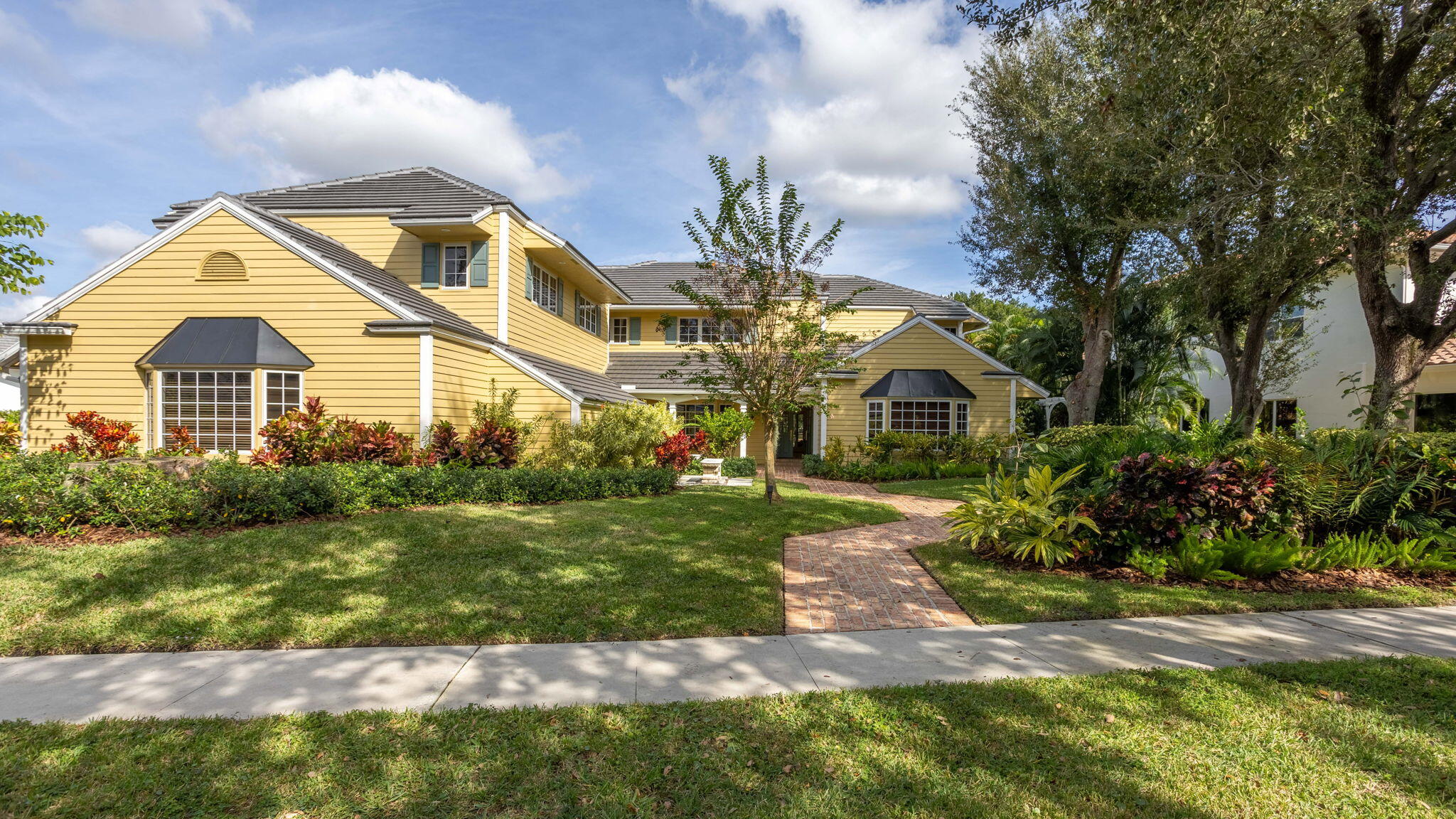 Stunning Executive home in Boca Bath & Tennis!   This extraordinary estate delivers 7,654 sq ft. of inspired living where architectural artistry meets timeless sophistication on the community's coveted 14-acre lakefront park.  From the moment you enter, the home reveals meticulous craftsmanship, soaring volume, and sun drenched spaces that frame the shimmering lake at every turn.  Impeccable craftsmanship is felt throughout the 5+bedroom/6.2 bath home, enhanced by thoughtful architectural design and a warm, inviting floor plan.  Designed to embrace the tropical Florida landscape, the home features expansive impact windows that flood every room with natural light and/or tranquil lake views.  The primary bed enjoys a private sitting area and a large 2nd flr patio overlooking the pool & lake For peace of mind, the property includes a whole-house generator and full hurricane-impact glass. At the heart of the home lies a chef's dream kitchen - a dramatic culinary stage appointed with granite surfaces, custom millworker, a commercial-grade gas range, and both a full-size refrigerator and freezer.  The oversized island anchors the space, while the breakfast area captures sweeping patio and lake views that feature patio, garden and lake views that make you feel like you're at a five star resort!  A four car garage , luxurious materials, and meticulous upkeep complete this far offering - one of Boca Bath & Tennis's most compelling lake front homes.