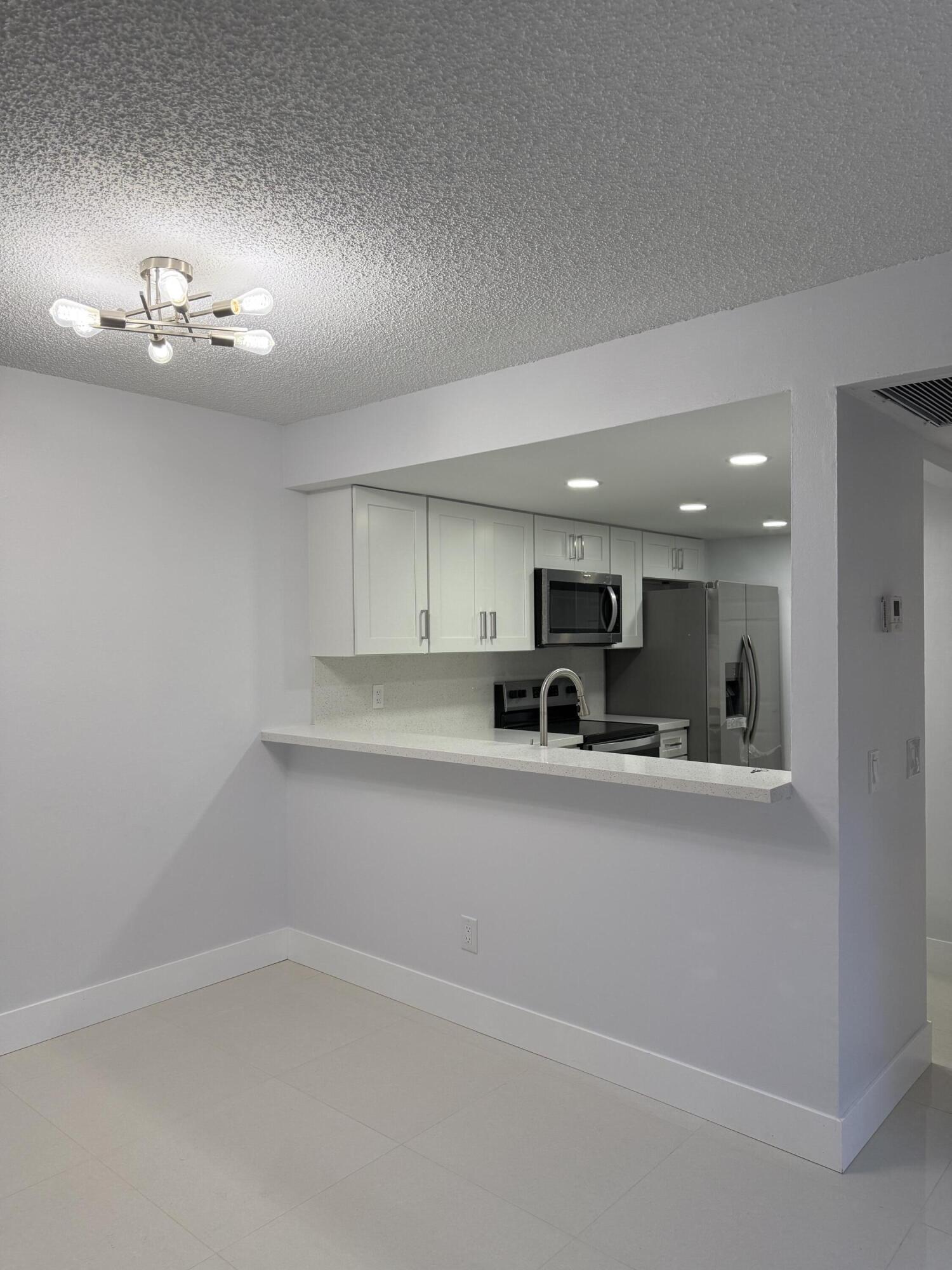 COMPLETELY UPGRADED CORNER VILLA, MOVE-IN READY! Unique opportunity to rent a home with EVERYTHING COMPLETELY REMODELED, making you feel like you're living in a BRAND-NEW HOME. 3 Bedroom 2 Bathrooms with 2 enclosed patios and assigned parking spaces conveniently located right in front of the home. Enjoy elegant 24" x 24" porcelain tile throughout. BRAND-NEW appliances. NEW kitchen cabinets with modern QUARTZ countertops. NEW lighting. NEW closet doors. COMPLETELY REMODELED master bathroom with NEW vanity. NEW ceiling fans. NEW front entry fence. FRESH INTERIOR PAINT with modern, upscale finishes throughout. NO HOA APPROVAL REQUIRED, so you can MOVE IN IMMEDIATELY. The backyard offers DIRECT ACCESS to the playground and pool. GATED COMMUNITY WITH SECURITY GUARD  with Pool, Gym, Tennis, etc New water heather, newer roof.  The community is in the process of painting the building and fences.