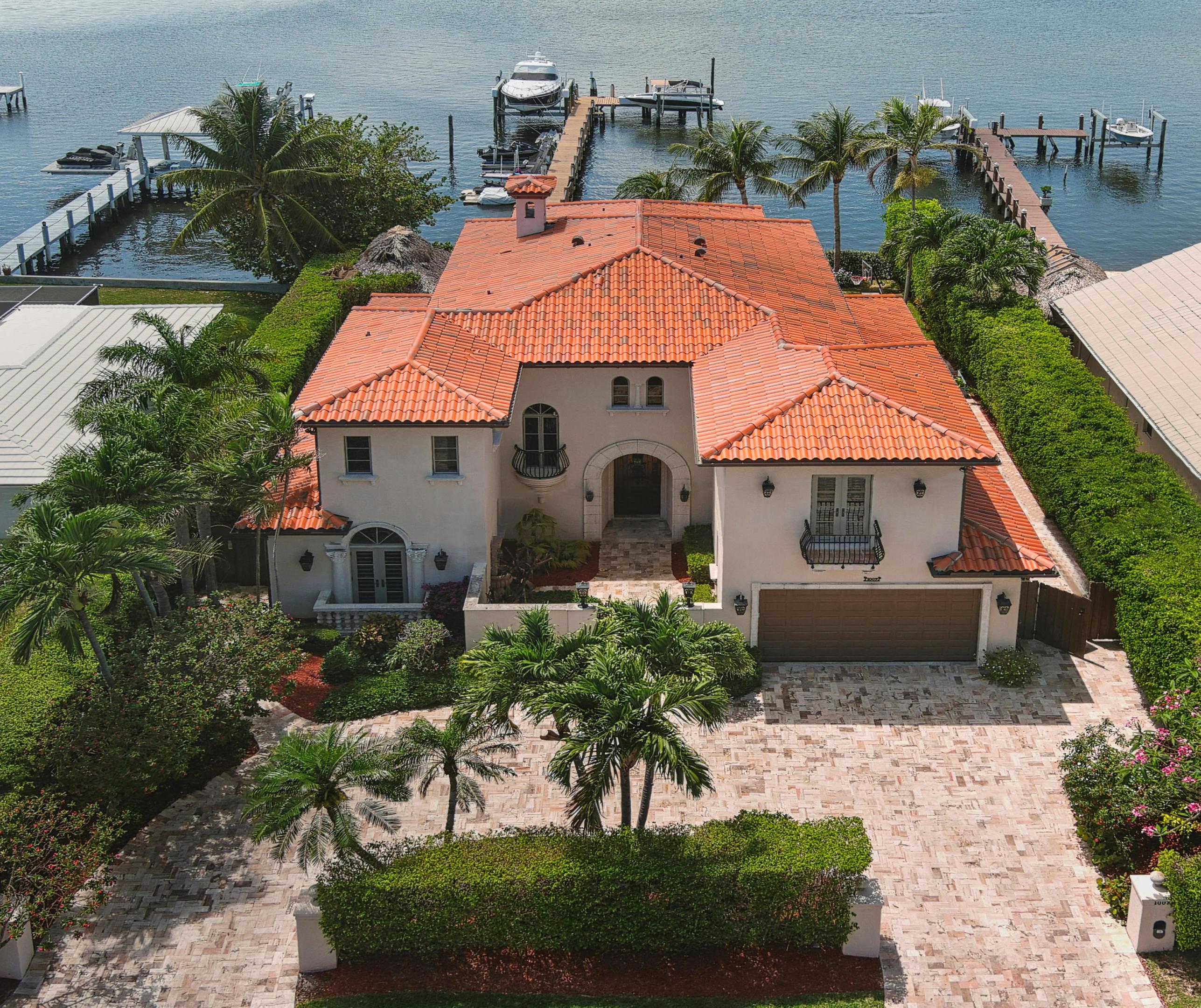 Overlooking the expansive views of the Intracoastal, this spectacular Mediterranean-style 5 bdrm 6.5 bath estate boasts fully renovated dining, living, family, office, upstairs master, and custom designed kitchen w/ backlit quartz countertops & oversized island. All bedrooms are en suite, while downstairs master functions as a billiards/game room. Natural light abounds from all impact windows and French doors providing fabulous views from nearly every room. Beautiful stone-paved patio w/ salt water pool, tiki hut, cabana bath, and summer kitchen reflects the true essence of Florida living. Extensive dock w/ electric & water provides endless fun along the Intracoastal Waterway and Atlantic Ocean w/ three lifts for boats, jet skiis, and plenty of space for paddle boards, kayaks & water toys. The highly desirable and sought-after neighborhood of Hypoluxo Island is part of the town of Lantana, and is nestled between Manalapan and South Palm Beach as a natural island within the Intracoastal Waterway (this property is located within a NO WAKE zone). Enjoy a scenic drive along A1A to Palm Beach or Delray Beach, with quick and easy access to PBI Airport. It's a friendly community of approximately 300 residences, voluntary POA, canopy tree-lined streets and short distance to the beach, Plaza del Mar, Eau Resort and Spa, Old Key Lime House, and shops and restaurants along Ocean Ave.