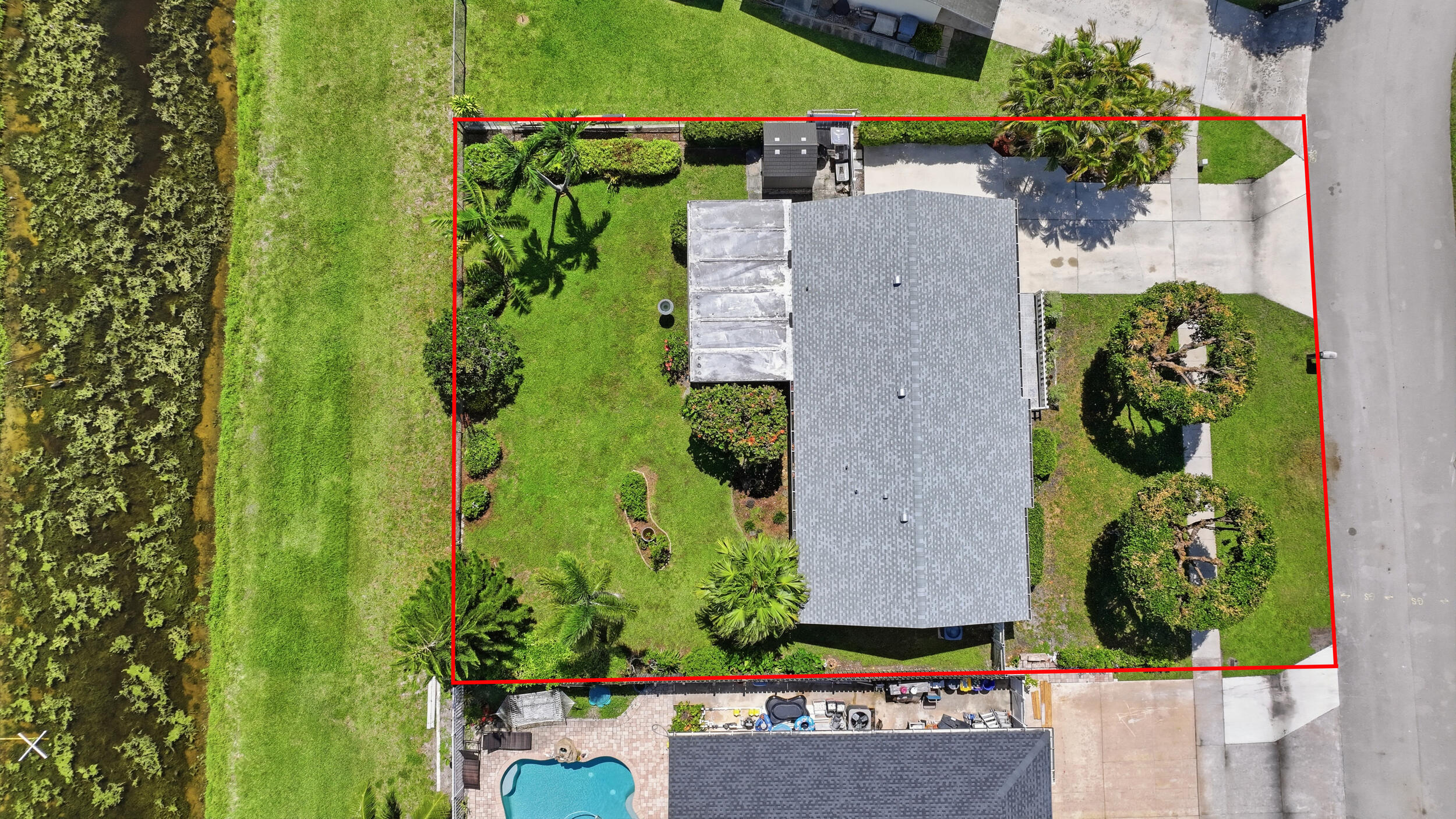 Welcome home to this meticulously maintained three-bedroom, one-bathroom, one-car garage waterfront home located in the highly desirable, extremely low-HOA community of Le Chalet. Owned and lovingly maintained by the original owner since it was built, this home reflects years of exceptional care and pride of ownership. Situated within an excellent school district, this home offers the perfect combination of comfort, convenience, and Florida living.    As you arrive, you'll immediately notice the lush landscaping, decorative white fence surrounding the inviting front porch, and extended driveway providing plenty of room for additional parking, including space for a boat or RV. Notable updates include a newer roof completed in 2024 and A/C replaced in 2023.   Inside, you'll find a bright and welcoming layout featuring wood-look vinyl flooring throughout, soaring cathedral vaulted ceilings, and an abundance of natural light.   The kitchen is equipped with solid wood cabinetry, under-cabinet lighting, dual sink with disposal, updated hardware, newer LG refrigerator, and a conveniently located breakfast nook perfect for casual dining.  Off the kitchen, the formal dining area flows seamlessly into the generously sized living room, both featuring updated fixtures and large windows that bring in plenty of natural light. French doors off the dining area lead to your private screened-in patio, creating the perfect indoor-outdoor living space.    The primary bedroom offers plenty of space with wood-look vinyl flooring, updated ceiling fan, and a large walk-in closet. The two secondary bedrooms feature matching flooring, ample closet space, and great natural light throughout.    Step outside to your private screened-in and covered patio, the perfect spot to enjoy your morning coffee or entertain guests. The spacious backyard is fully fenced and beautifully landscaped, with a peaceful canal backdrop offering the ideal setting to enjoy the best of Florida outdoor living.    Located in the heart of Boynton Beach, this property offers the perfect blend of convenience and lifestyle. Enjoy being within walking distance to Publix, making everyday errands effortless, while also being just minutes from a variety of shopping, dining, parks, and entertainment options. With easy access to major roadways including I-95, commuting throughout Palm Beach County is a breeze. Whether you're heading to the beach, exploring nearby attractions, or enjoying everything Boynton Beach has to offer, this location provides the ideal South Florida lifestyle.