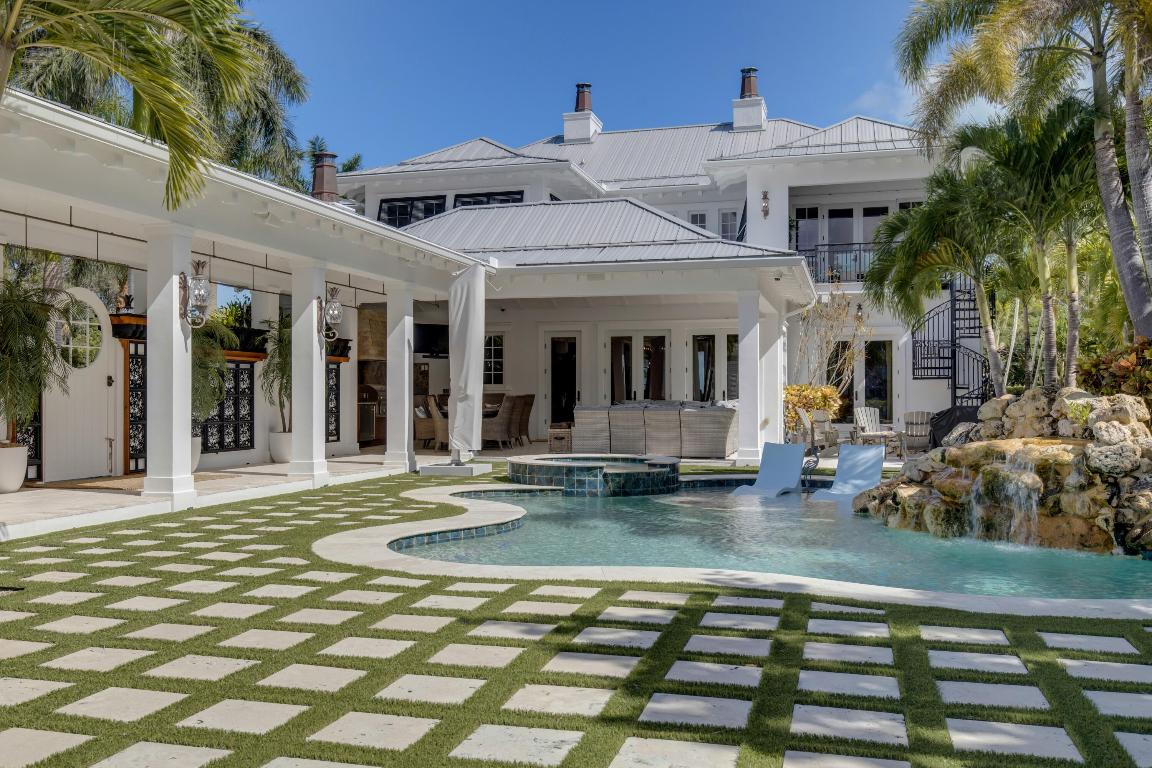 Nestled atop a serene hill with an exclusive view of the Intracoastal Indian River Lagoon, this waterfront oasis offers an unrivaled combination of Palm Beach elegance and the peaceful, modern lifestyle of Ft Pierce, Florida. Stepping into the foyer of this remarkable custom home, designed by the prestigious Janssen Architects of West Palm Beach, the discerning eye will immediately recognize the artistry and craftsmanship that went into creating this extraordinary residence. Every detail speaks to quality: state-of-the-art dock minutes to the ocean, award winning pool, artisan-wrought iron staircase, hand-carved Volte, custom-made lighting fixtures, exquisite fireplaces, & the warmth of Hickory hardwood floors underfoot. Soaring ceilings create an atmosphere of grandeur, elegance & space. The heart of this home, undoubtedly, is the chef's kitchen. It boasts a Wolfe Range, custom cabinetry, and exotic countertops. The kitchen seamlessly flows into the dining and living rooms, both bathed in natural light from the 9-foot-tall windows that frame captivating views of the sun dancing on the river. The first floor also hosts a magnificent den/study and two guest suites, offering unparalleled convenience and privacy.   A private elevator whisks you to the expansive second-floor master suite, complete with a sitting room, providing you with a private sanctuary to watch the spectacular moonrise over the river. All three additional bedrooms with en-suite bathrooms are equally impressive, offering their own breathtaking views and seclusion for your guests.   Outside, the two front porches that span the length of the house beckon you to pause and take in the parade of boats making their way down the waterway to the ocean, just minutes from your doorstep.   This property is made for legendary parties, perfect for entertaining family and friends in a tropical setting. The outdoor kitchen and living area set the stage for memorable gatherings. The award-winning swimming pool adds to the festivities with lush landscape lighting, a cascading rock waterfall, and a path that leads to the glass botanical Orchid House.   Stroll along meandering trails through tropical gardens on this expansive 4.5-acre estate. Discover a picturesque path leading from the approximately 100 feet of waterfront along the Intracoastal Waterway to the serene Savanah Preserves that grace the property's rear.   For the fishing enthusiasts in the family, rejoice in the quick ocean access with no fixed bridges offered by the newly built state-of-the-art dock with 2 boatlifts, making deep-sea fishing in the Gulf Stream or a day of watersports along the Indian River a breeze.   This Shangri-La has a practical side too, with RV/Boat Parking, an oversized 3-car garage, impact windows, and a generator to ensure your peace of mind.  Don't Miss This Once-In-A-Lifetime Opportunity! Call Today to Schedule Your Exclusive Showing on This Remarkable Piece of Paradise as Your Own.   (Sizes and Measurements are approximate. Buyer to verify all information)