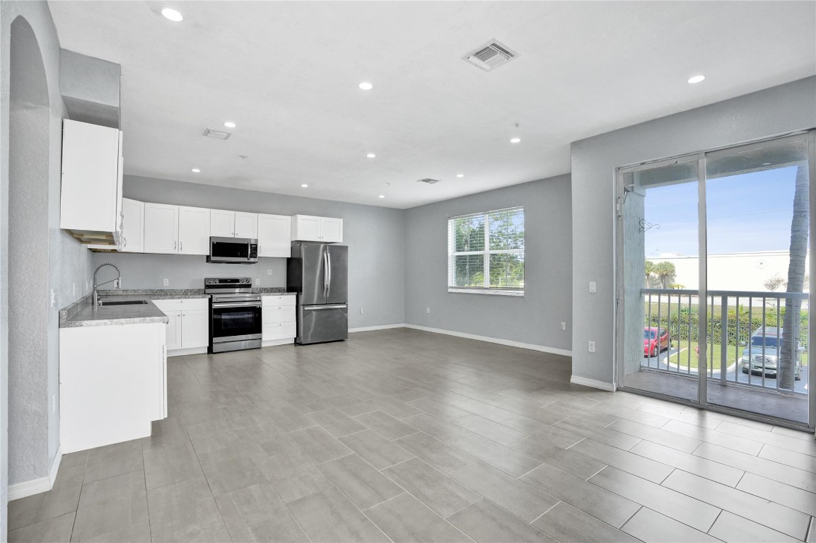 LOCATION! This condo is located in one of the Wellington's most prestigious and desirable areas, offering both convenience and high property value potential. Two-story condo designed for comfort, privacy, and modern living. Two master suites-ideal for families, roommates, or guests. Half bath on the first floor for convenience. Laundry room located inside the unit. Title throughout, making the home easy to clean, allergy-friendly, and visually cohesive. Kitchen completely updated. Open layout design, perfect for entertaining and modern living. Stainless steel appliances. Private view, offering peace and privacy. Balcony adds outdoor living space, perfect for relaxing. New roof, AC & community is being beautifully repainted. Investor friendly.