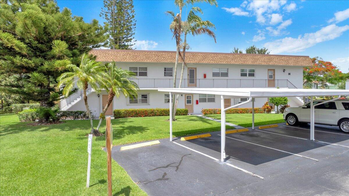 Welcome to this first-floor corner 2-bedroom, 2-bath unit in the highly desirable 55+ Kingswood community. Filled with natural light, this spacious unit features generous bedrooms, abundant storage, and an assigned covered carport. Accordion shutters offer added peace of mind. Enjoy a large screened patio with a private garden view, perfect for morning coffee or evening relaxation. Kingswood offers resort-style amenities including tropical grounds, a pool, clubhouse, shuffleboard, walking trail, and putting green. Ideally located just minutes from Stuart's pristine beaches, charming Downtown Stuart, shopping, dining, and medical facilities. Move-in ready and perfectly positioned for easy coastal living.