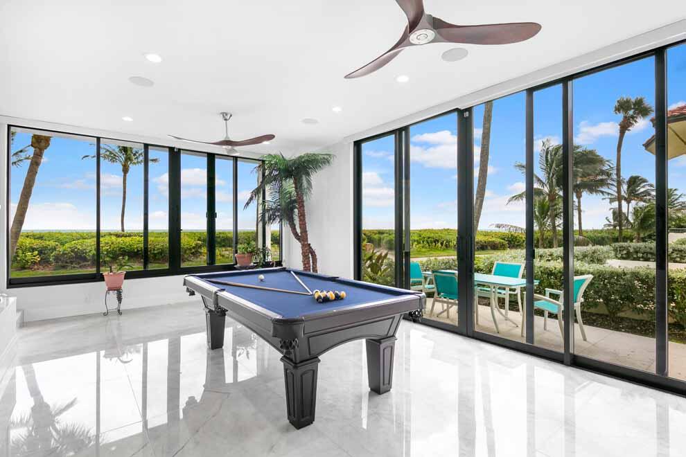 Newly renovated, this oceanfront residence in Ocean Ridge offers scenic ocean views, abundant privacy, and dedicated town police department. Boasting over 5,000 total square feet, the freestanding townhome has main and upper level living areas, and three bedrooms plus office. Updates include new impact glass windows and doors; new marble, wood and porcelain floors; new kitchen with Monogram appliances; new bathrooms plus sauna; new lighting and electrical; new stairs and railings; new full bar; new automated shades; new washer and dryer; and whole-house dehumidifier. Enjoy the seaside community pool and beach path to private beach. Diamond Beach is a private enclave of just 7 townhouses that allows pets and leasing with restrictions. Perfect for year-round living or South Florida getaways. FEATURES:
" Freestanding residence in prime oceanfront location
" Ocean views, beach path and private beach
" Diamond Beach Complex has just 7 townhouses
" Town of Ocean Ridge offers Town Hall and private police department
" Newly renovated with updates throughout
" 3 bedrooms plus office / 3.1 baths 
" 3,789 square feet under air / 5,077 total square feet
" Three stories including three-car garage
" Coastal contemporary finishes with glass windows and sliders for natural light
" Foyer entry with main floor living area view ocean views, marble floors, and sliding door access to outdoor dining area
" Brand new kitchen with Monogram appliances, island with snack bar seating, dining area and nearby powder room
" Main floor office
" Main floor guest bedroom with full bath and sliders to covered patio
" Conveniently located stairway for easy access garage and upper level 
" Upper level landing opens to full bar and multi-purpose living area with stunning ocean views and spacious seaside covered balcony
" Master bedroom with stunning ocean views; wood floors; walk-in closet; and luxurious master bath with dual sinks; separate tub; and large walk-in shower
" Upper level guest bedroom with full bath and custom sauna
" Main floor laundry room with full-size washer and dryer and access to exterior and path to pool
" Lower level three-car garage with ample storage
" Community pool with dining area
" Beach path to private beach

RENOVATIONS:
" New impact glass windows and doors
" New marble, wood and porcelain floors
" New kitchen with Monogram appliances
" New bathrooms plus sauna
" New lighting and electrical
" Fully wired for sound and network connection
" New stairs and railings
" New interior doors
" New full bar
" New automated shades
" New washer and dryer
" New fireplace and chimney
" Whole-house dehumidifier
" Spray insulation in attic