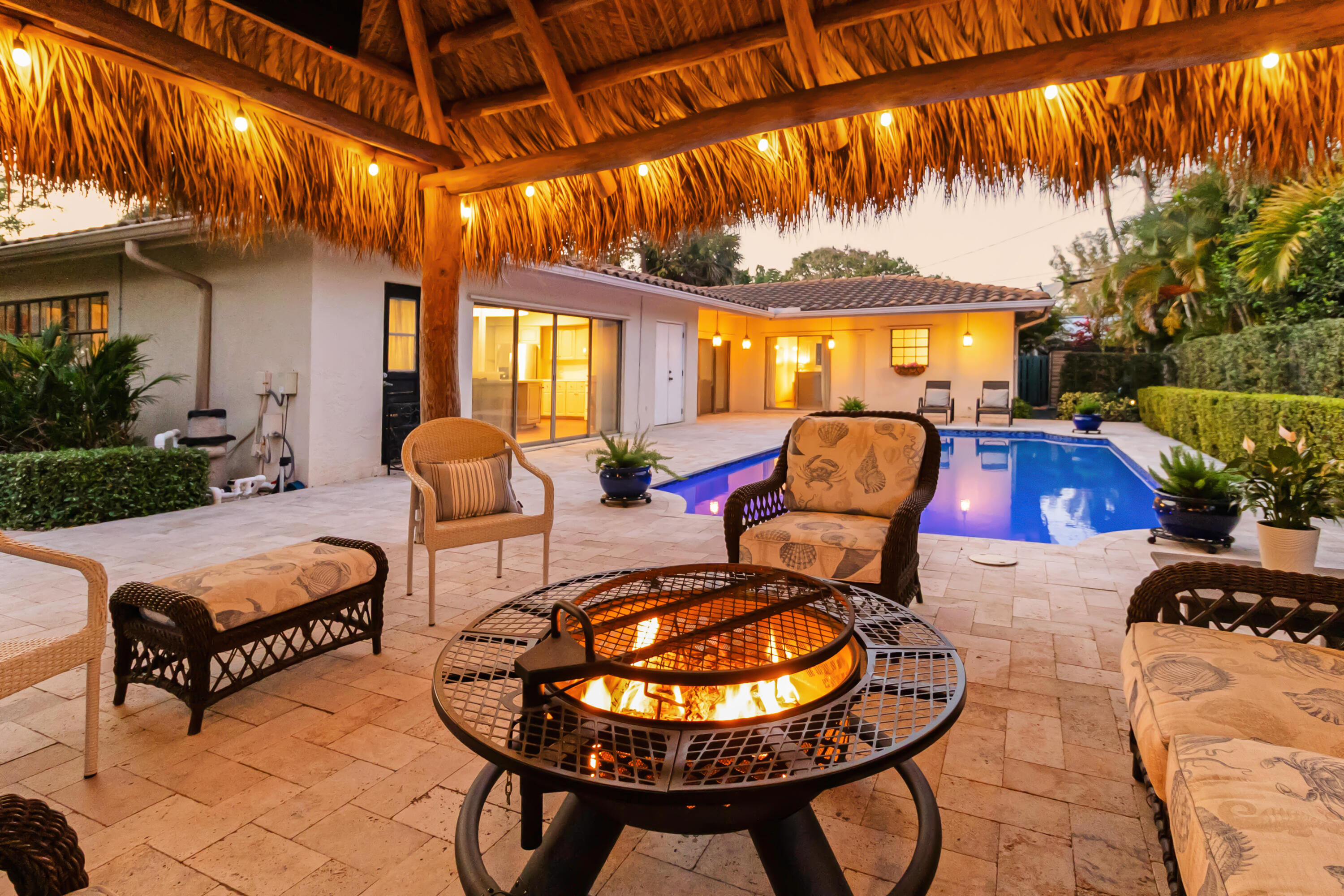Located just steps from the ocean in the highly sought-after Terra Mar neighborhood, this beautifully appointed 3-bedroom, 3-bathroom home with office and family room offers the ultimate barrier island lifestyle. Situated on a large corner lot with lush, mature landscaping, the property features nearly 3,000 square feet under air and multiple indoor and outdoor living spaces designed for both relaxation and entertaining. Inside, a spacious and inviting layout unfolds with a generous kitchen and dining area that serves as the heart of the home, ideal for hosting gatherings. The thoughtful floor plan includes a dedicated office and separate family room, providing flexibility for work, guests, or additional living space. Outdoor living is a standout feature, with a modern saltwater pool  complete with a water feature and travertine pool deck, creating a private resort-style setting. A fully equipped tiki hut with electricity  including lighting, fan, and TV, enhances the backyard experience, while a front courtyard and multiple seating areas offer additional spaces to unwind. Enjoy the convenience of a true coastal lifestyle, Terra Mar Island is a gated waterfront community of approximately 140 single-family homes, located right off A1A. The surrounding area features sidewalks throughout, making it easy to walk or bike to the beach or into Lauderdale-by-the-Sea for restaurants, shops, and nightlife. With only one way in and out, traffic stays light and the community maintains a quiet, residential feel. For boating enthusiasts, multiple nearby public boat ramps and marinas provide convenient access.  The location is also highly accessible for commuters: approximately 20 minutes to FTL Airport, 40 minutes to MIA, and 1 hour to PBI Airport. Terra Mar is a great option for buyers looking for a laid-back coastal lifestyle with beach access, walkability, and a true neighborhood feel. This is a rare opportunity to own a spacious home in one of the area's most desirable ocean-close communities.